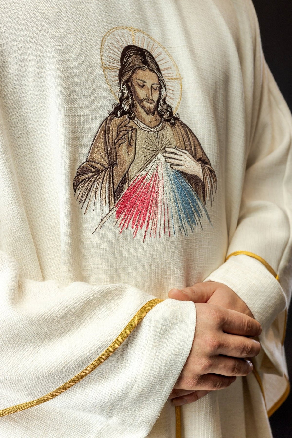 Ecru chasuble detail of Divine Mercy embroidery with red and blue rays