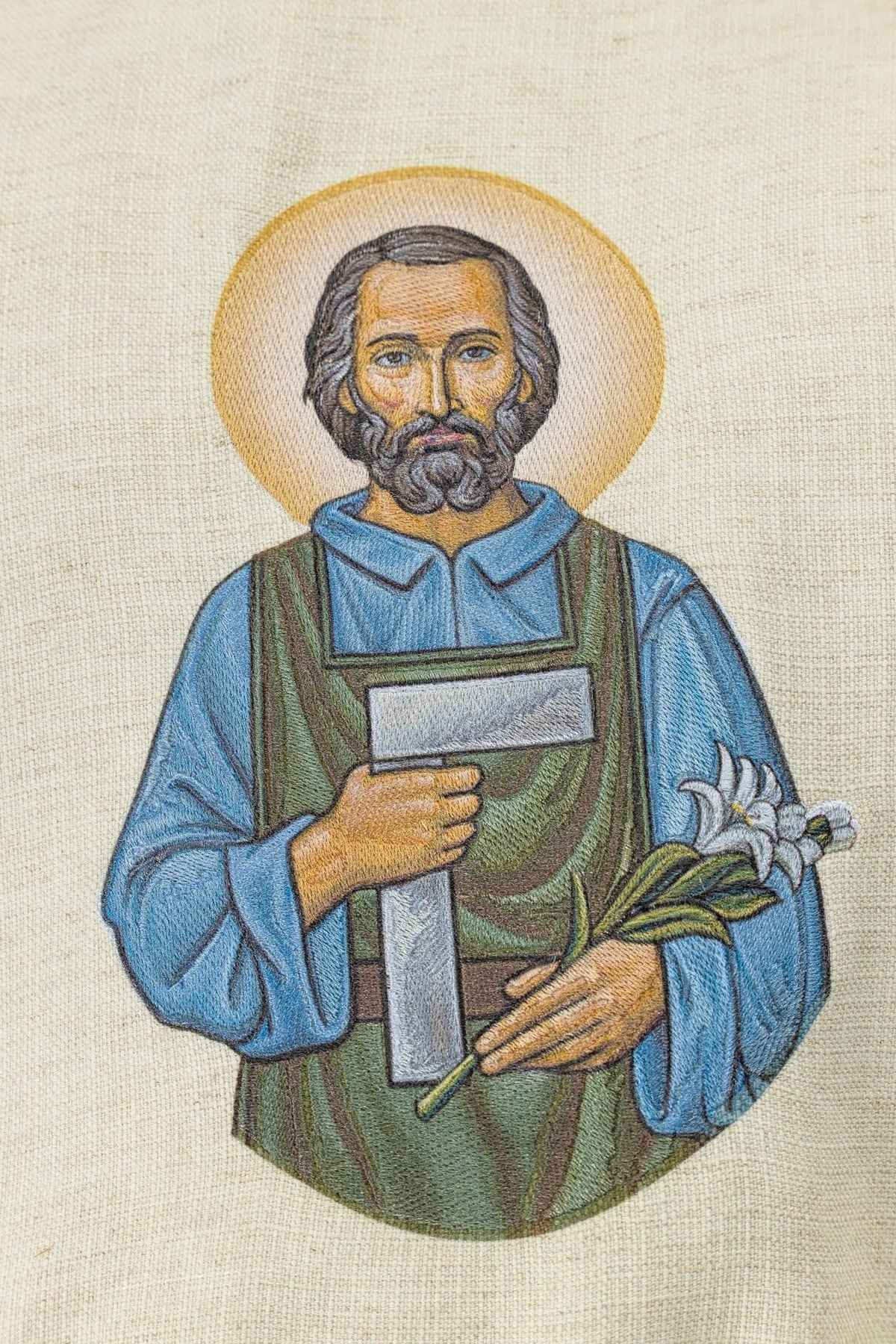 Saint Joseph the Worker chasuble, close-up of embroidered figure on ecru fabric