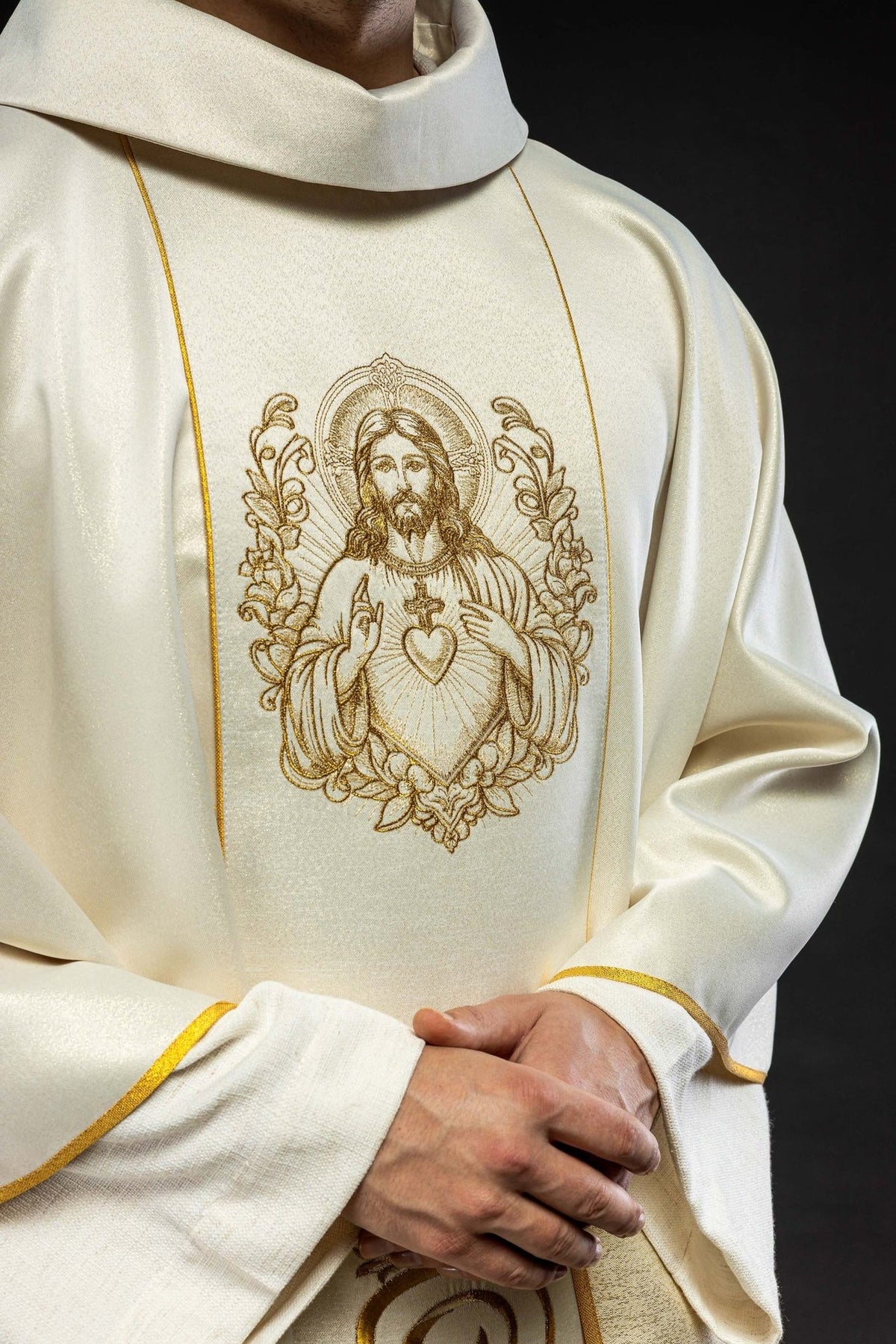 Ecru chasuble close-up showing Sacred Heart of Jesus embroidery and gold trim