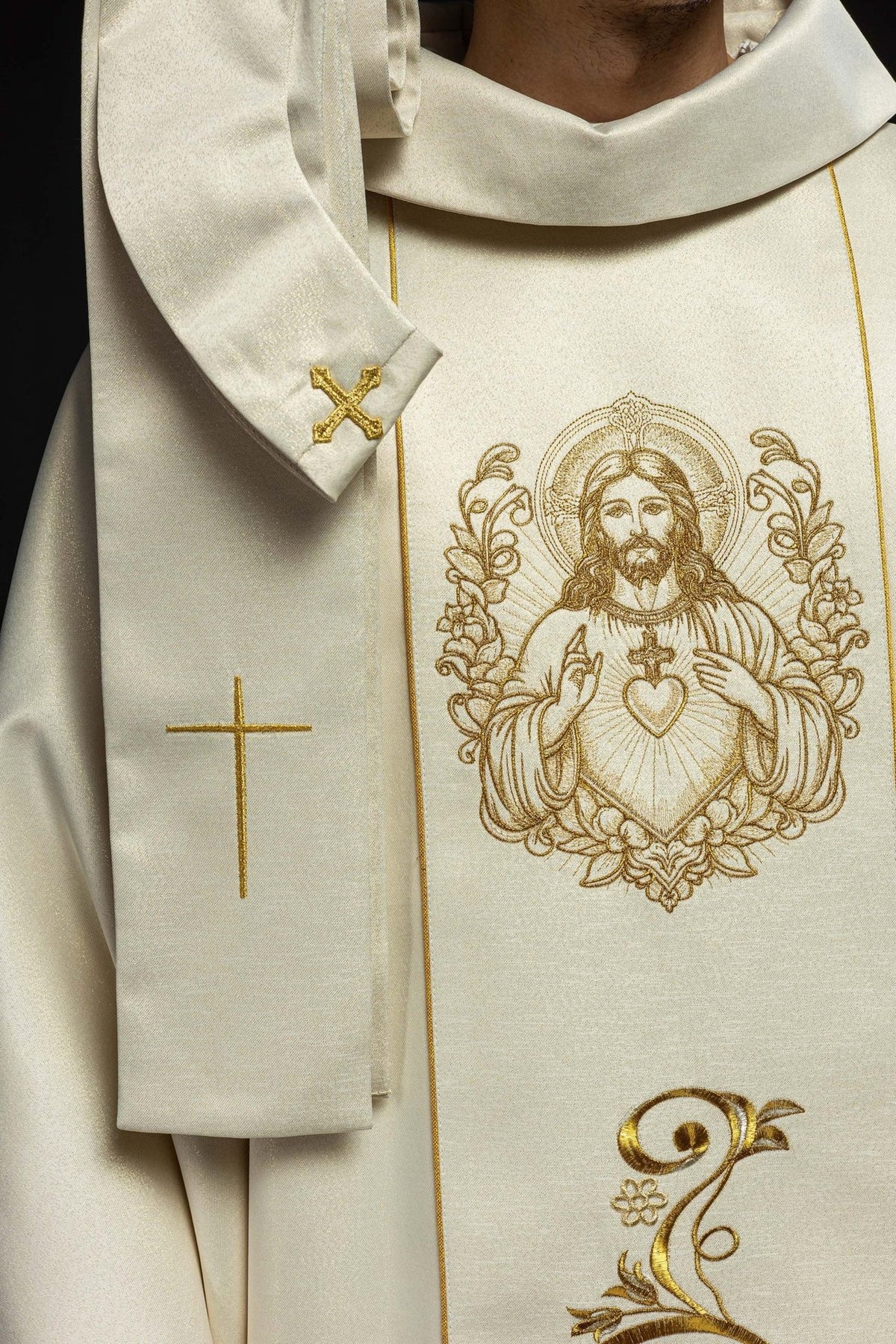 Ecru chasuble detail with Sacred Heart of Jesus embroidery, gold cross and stand-up collar
