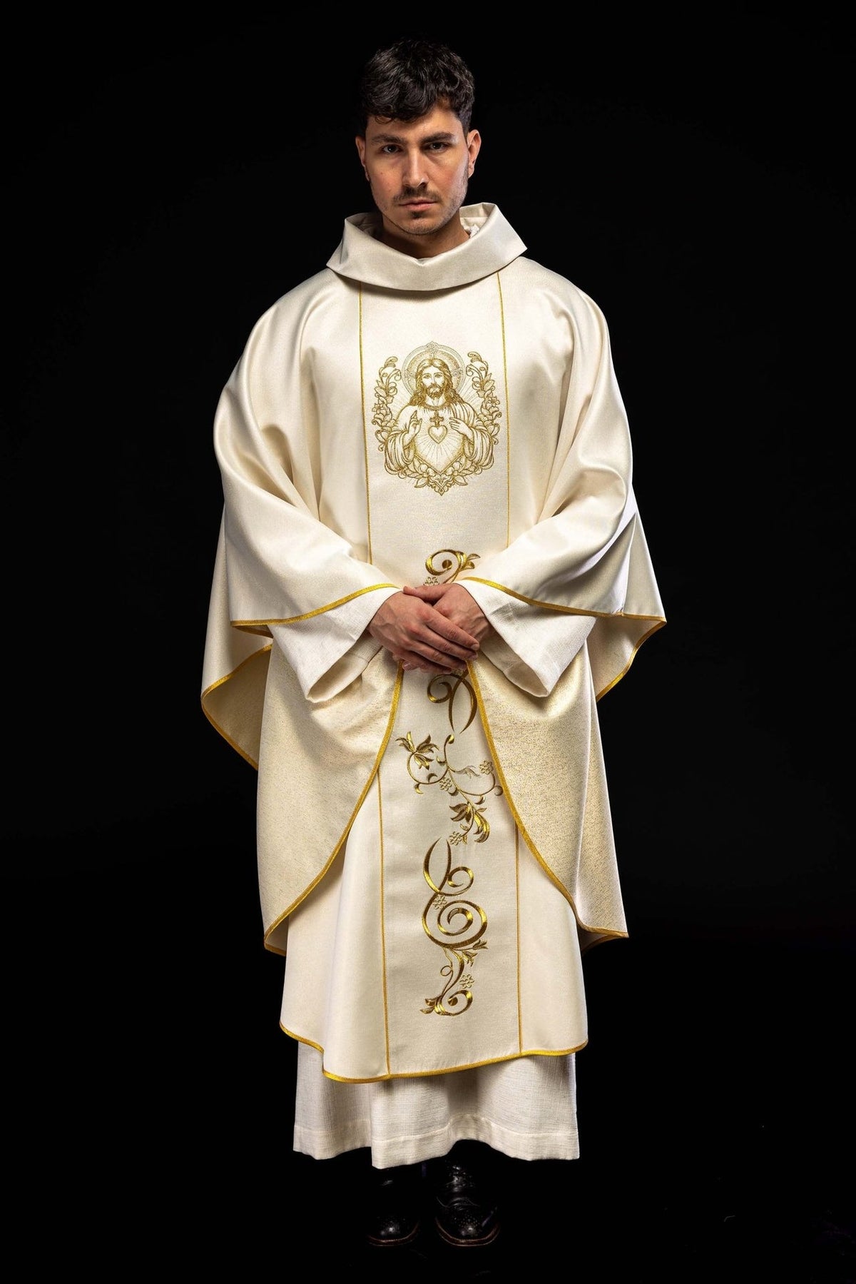 Ecru chasuble worn front view with Sacred Heart of Jesus embroidery and gold trim