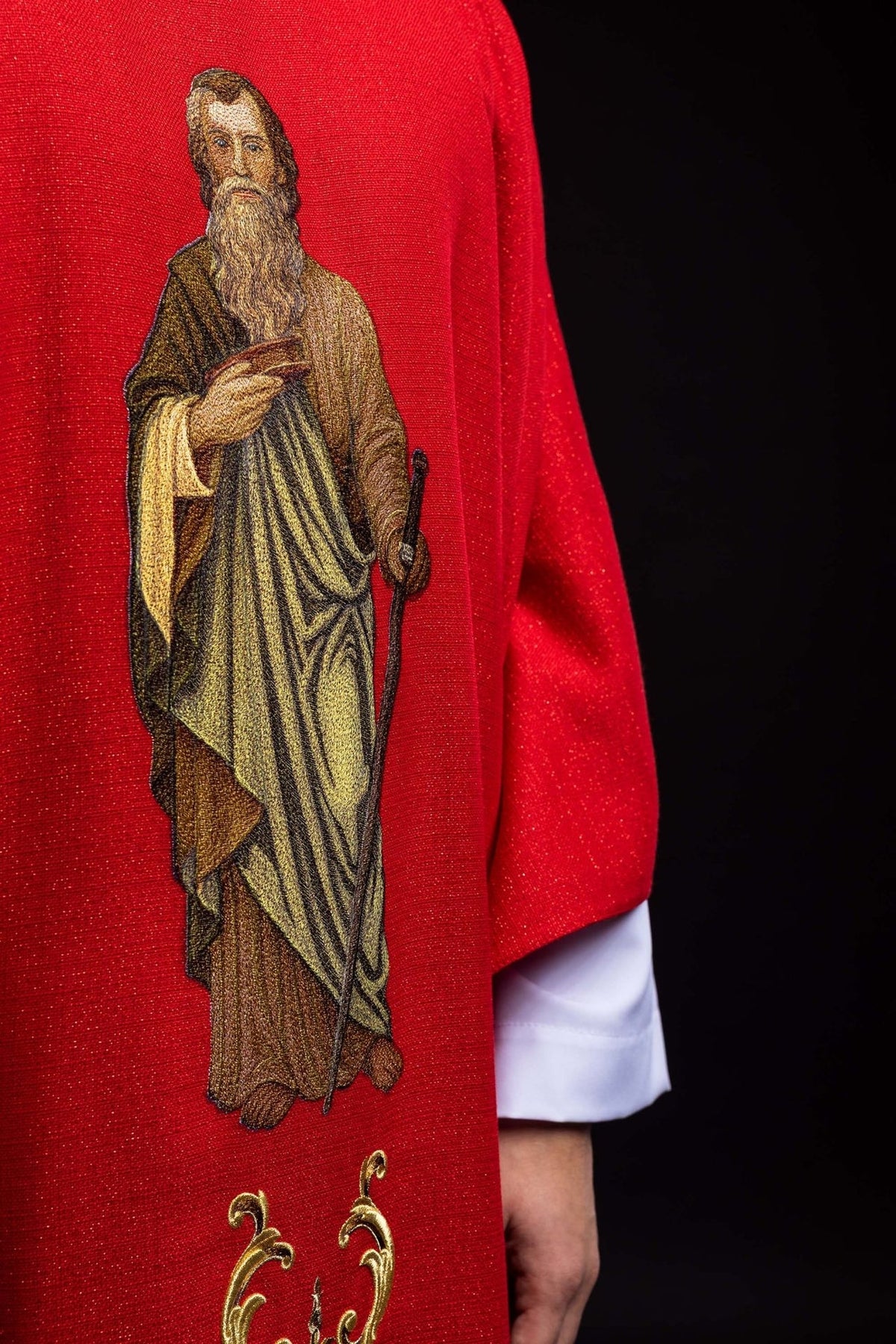 Red chasuble close-up showing embroidered Saint Paul image