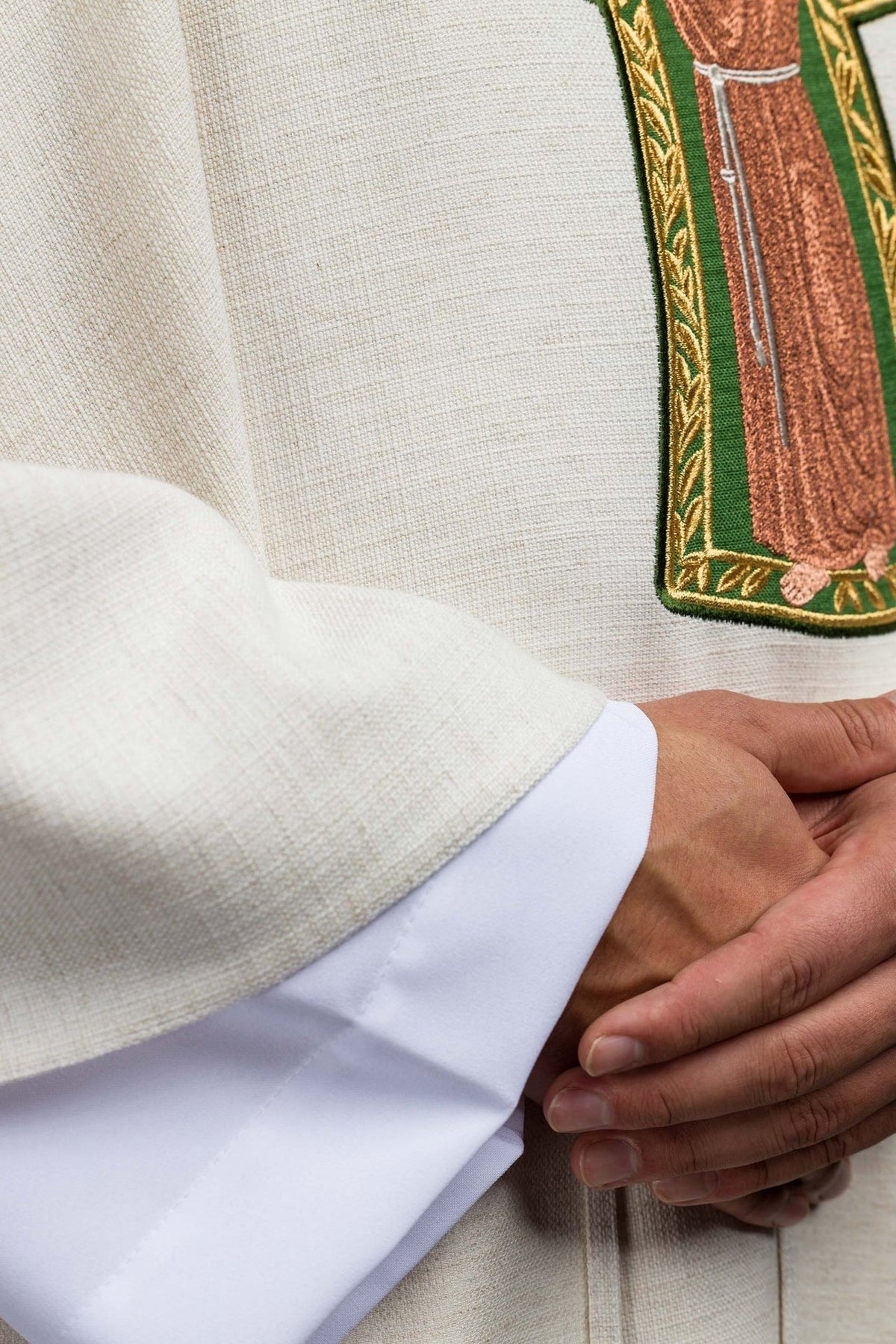 Saint Francis chasuble, close-up of cream fabric and embroidered image detail