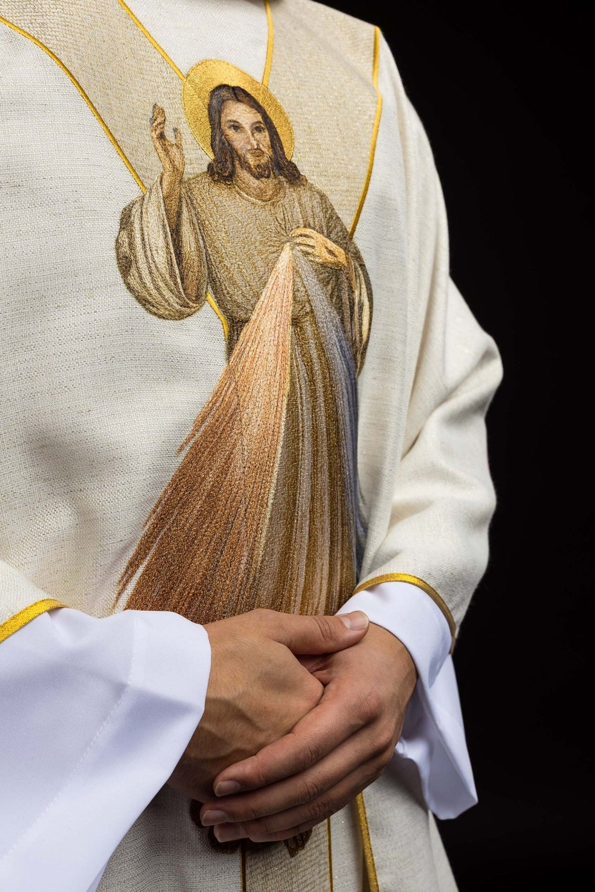 Ecru chasuble detail showing Divine Mercy embroidery and gold trim