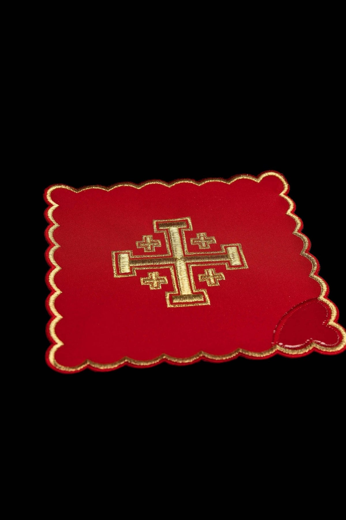 Red chalice pall with gold Jerusalem cross embroidery, close-up view