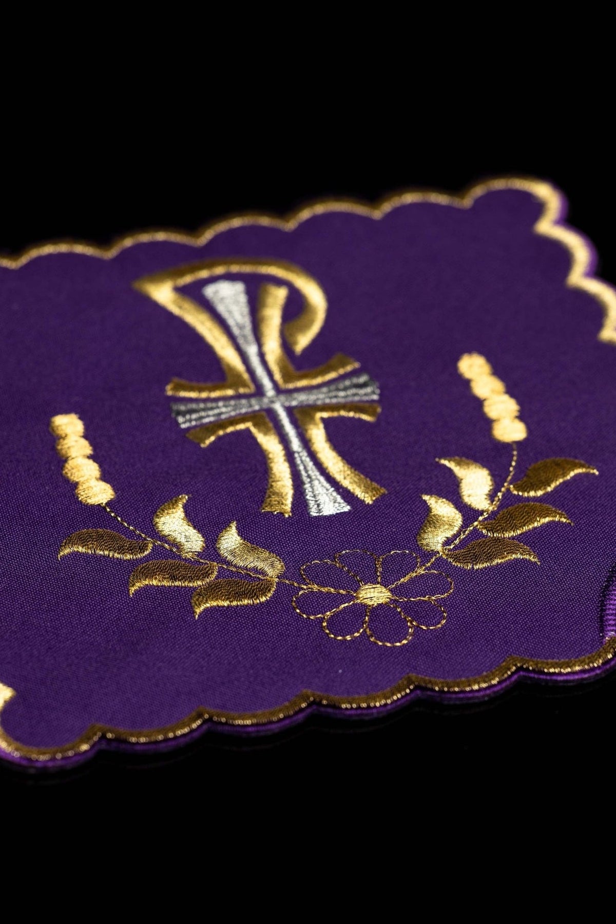 Purple chalice pall close-up with embroidered Pax symbol, cross and gold embroidery