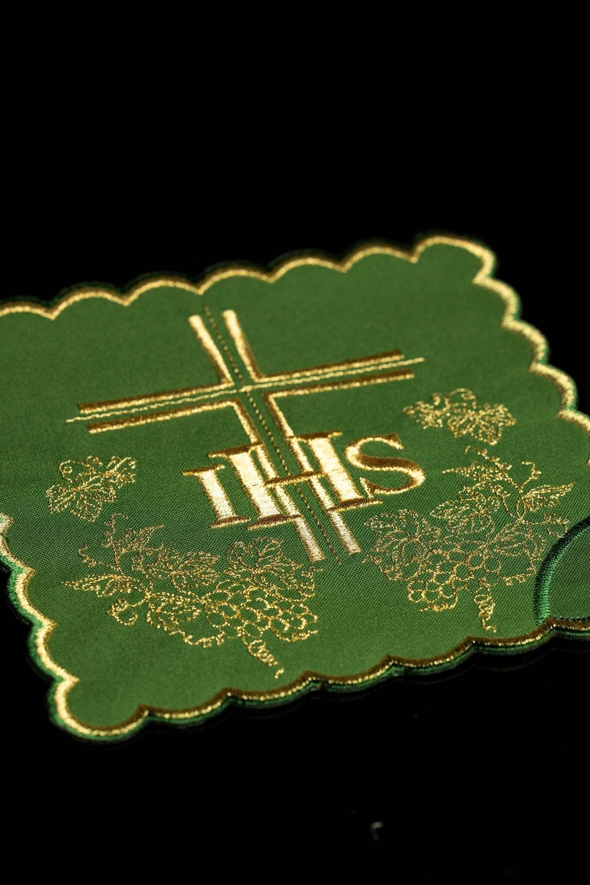 Green chalice pall close-up with gold IHS, cross and grape embroidery
