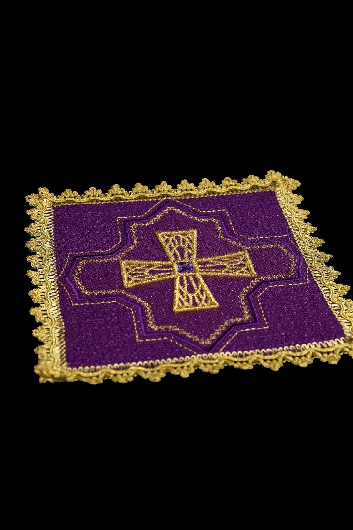 Purple chalice pall close-up with embroidered gold cross and ornate gold edging
