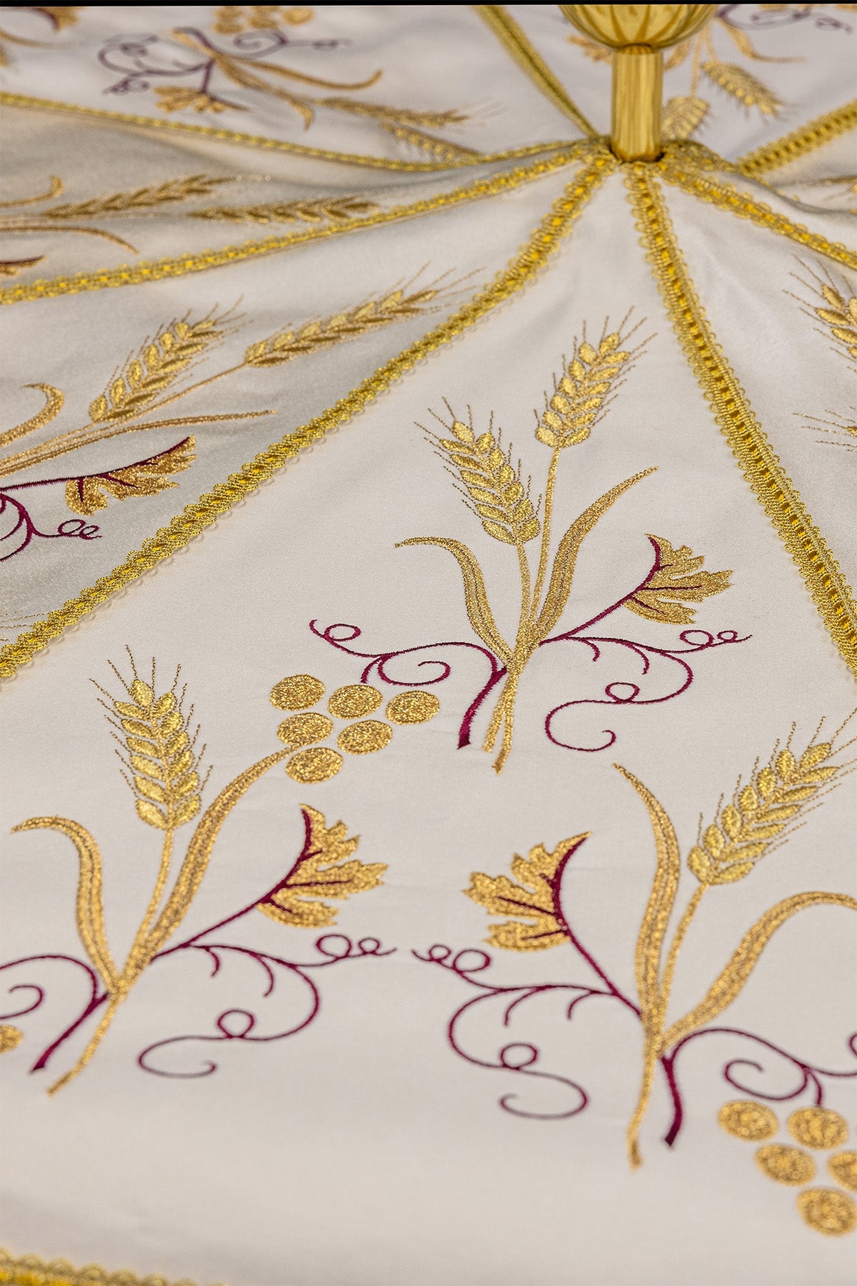 Ecru processional umbrella close-up showing gold wheat and grapes embroidery