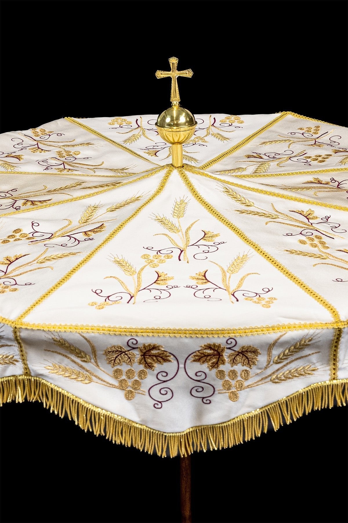 Ecru processional umbrella front view with gold cross finial and embroidered wheat and grapes