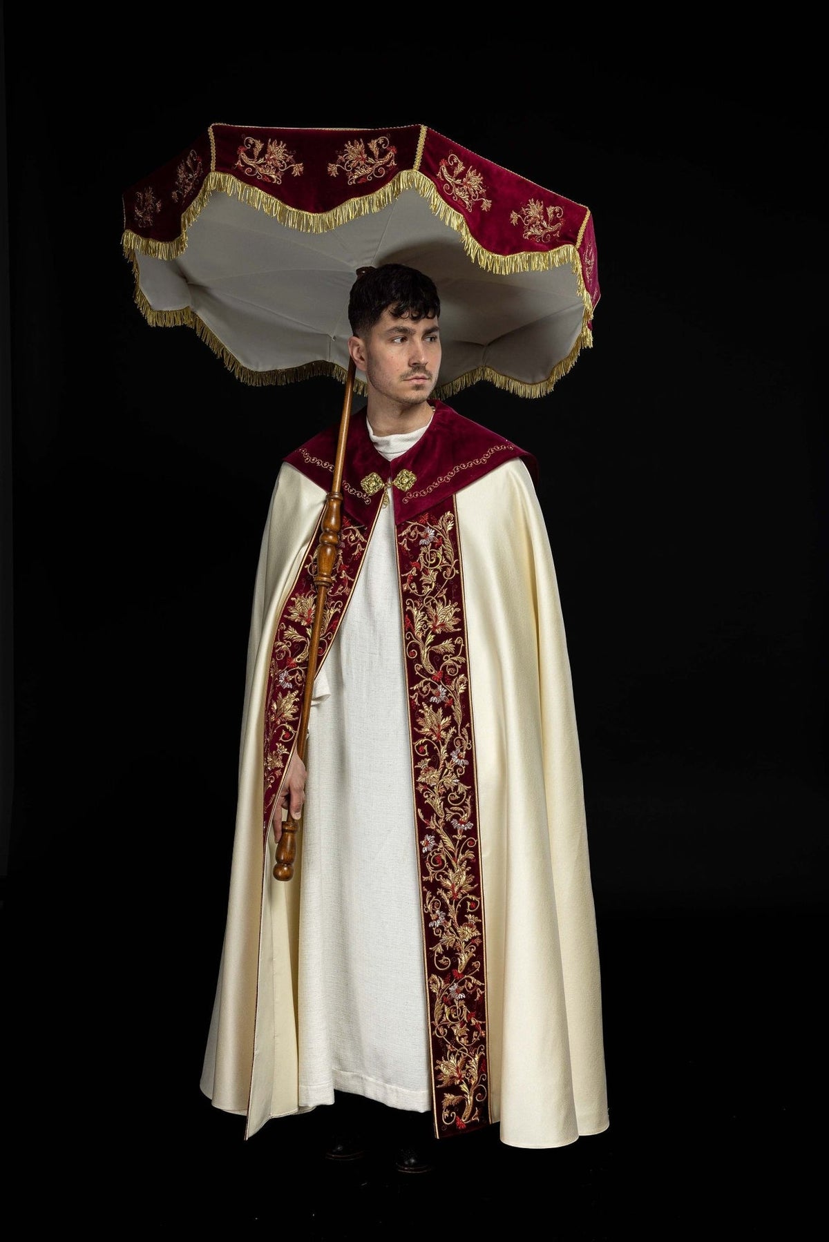Processional umbrella underside view showing ecru lining and burgundy embroidered valance