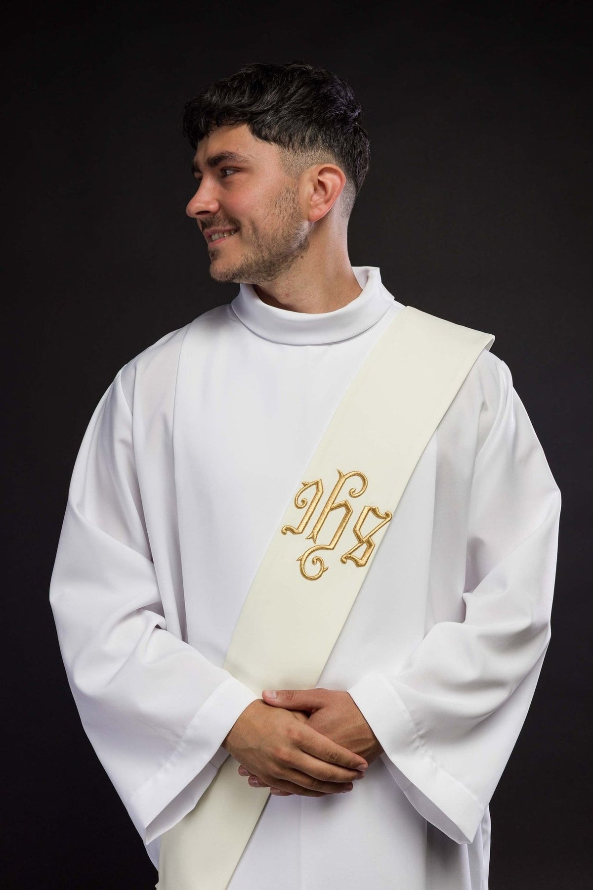 IHS deacon stole worn from the front, showing the ivory stole and gold embroidery