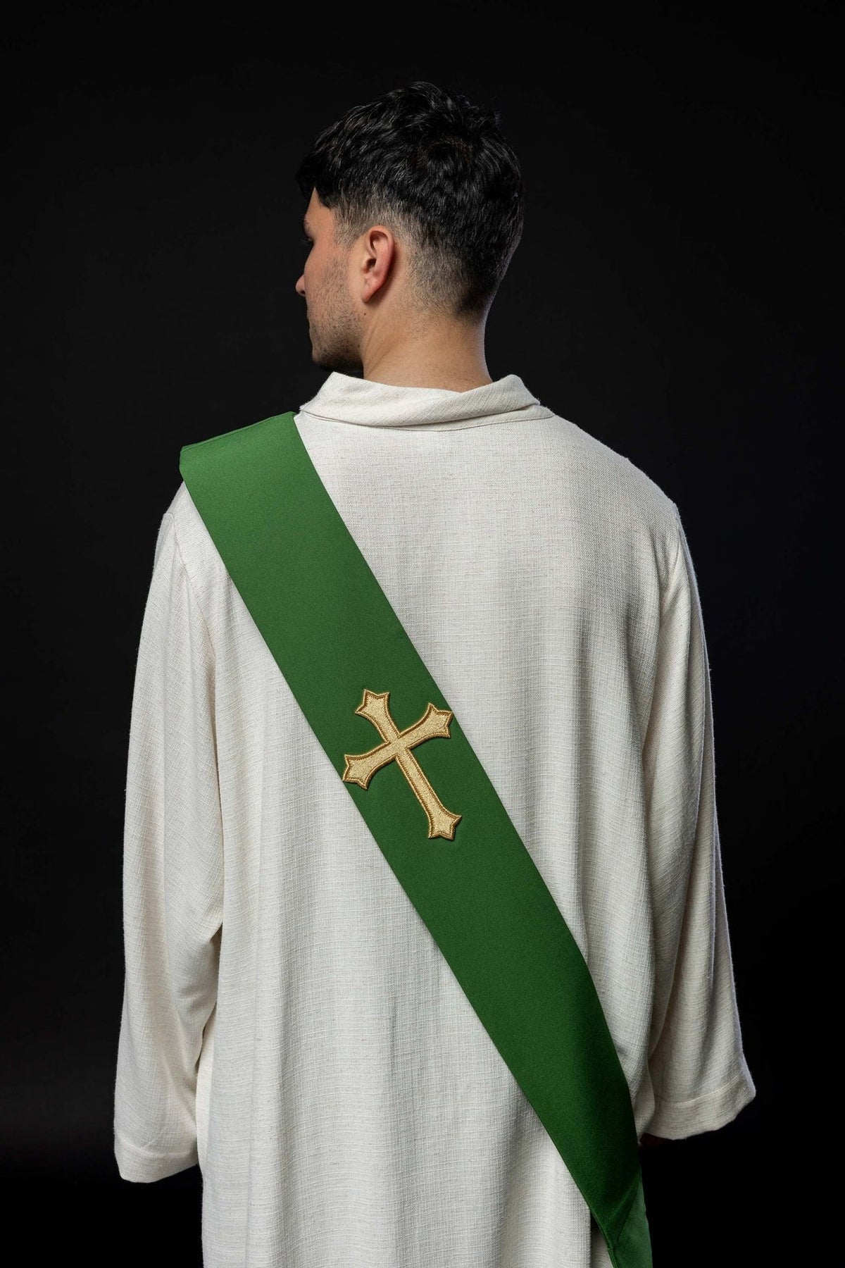 Green stole worn from the back with a gold embroidered cross