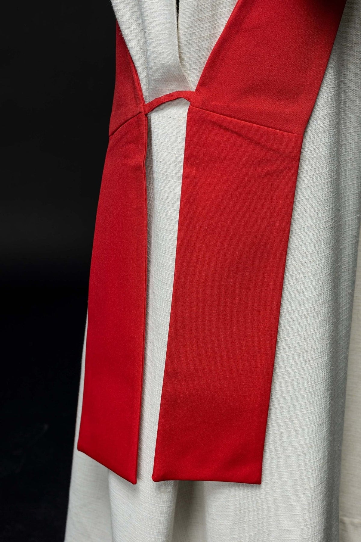Red stole close-up showing plain reverse side and joined ends