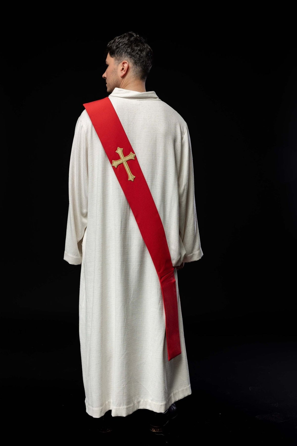 Red stole worn from the back, showing embroidered gold cross