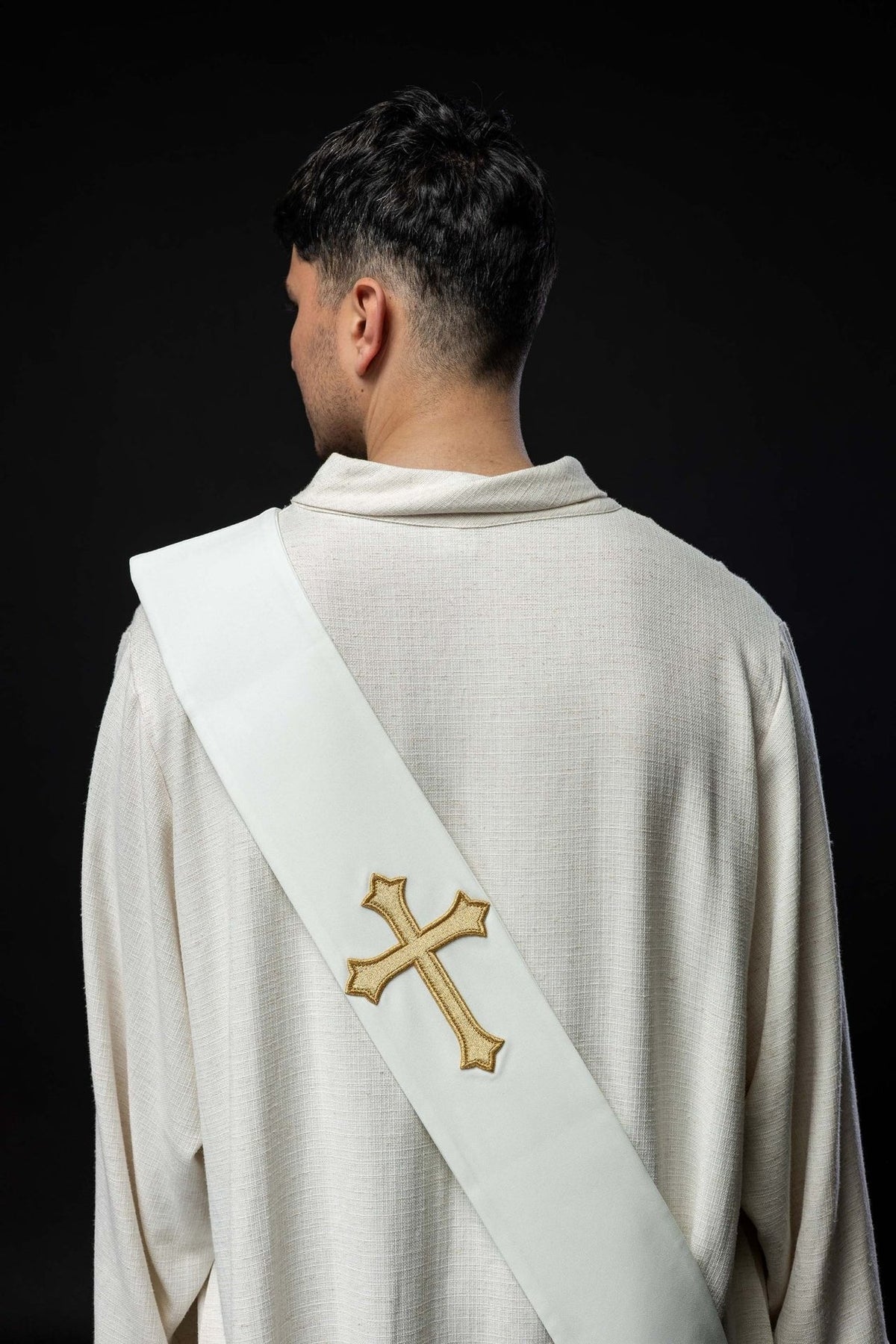 White stole worn from the back with a gold embroidered cross