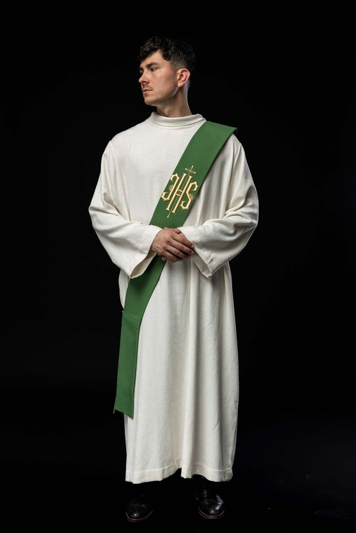 Green deacon stole worn in front view with gold IHS and cross embroidery