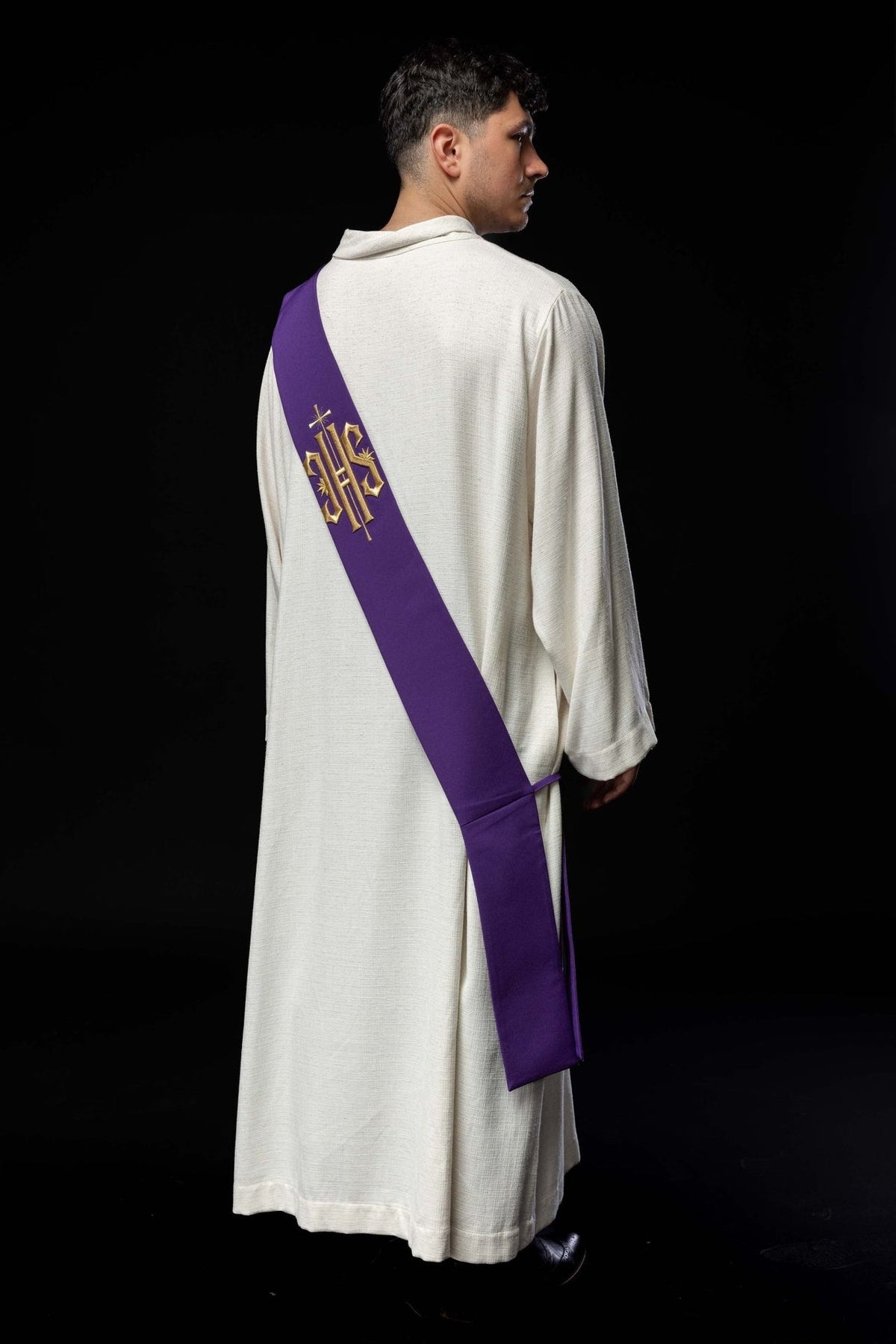 Purple stole worn from the back, showing embroidered IHS and cross