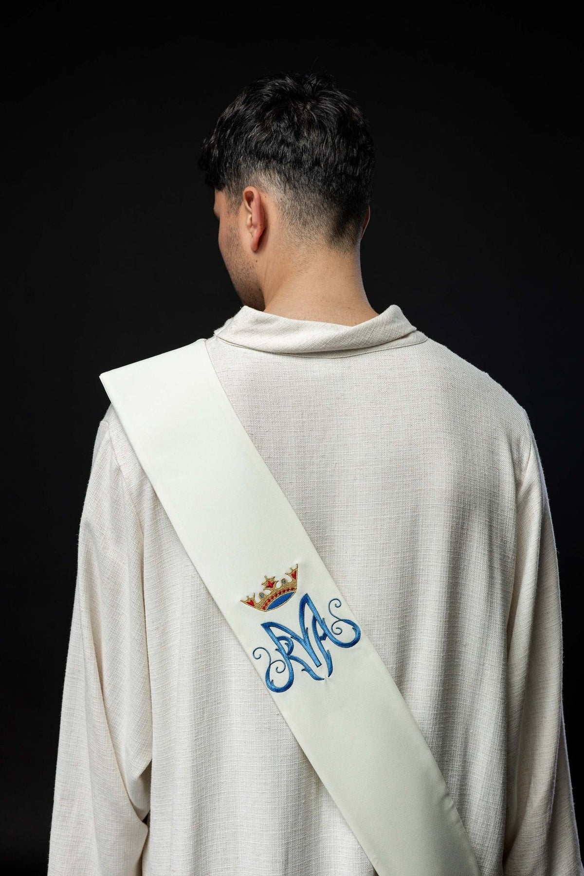Marian deacon stole worn from the back, showing embroidered Marian symbol and crown