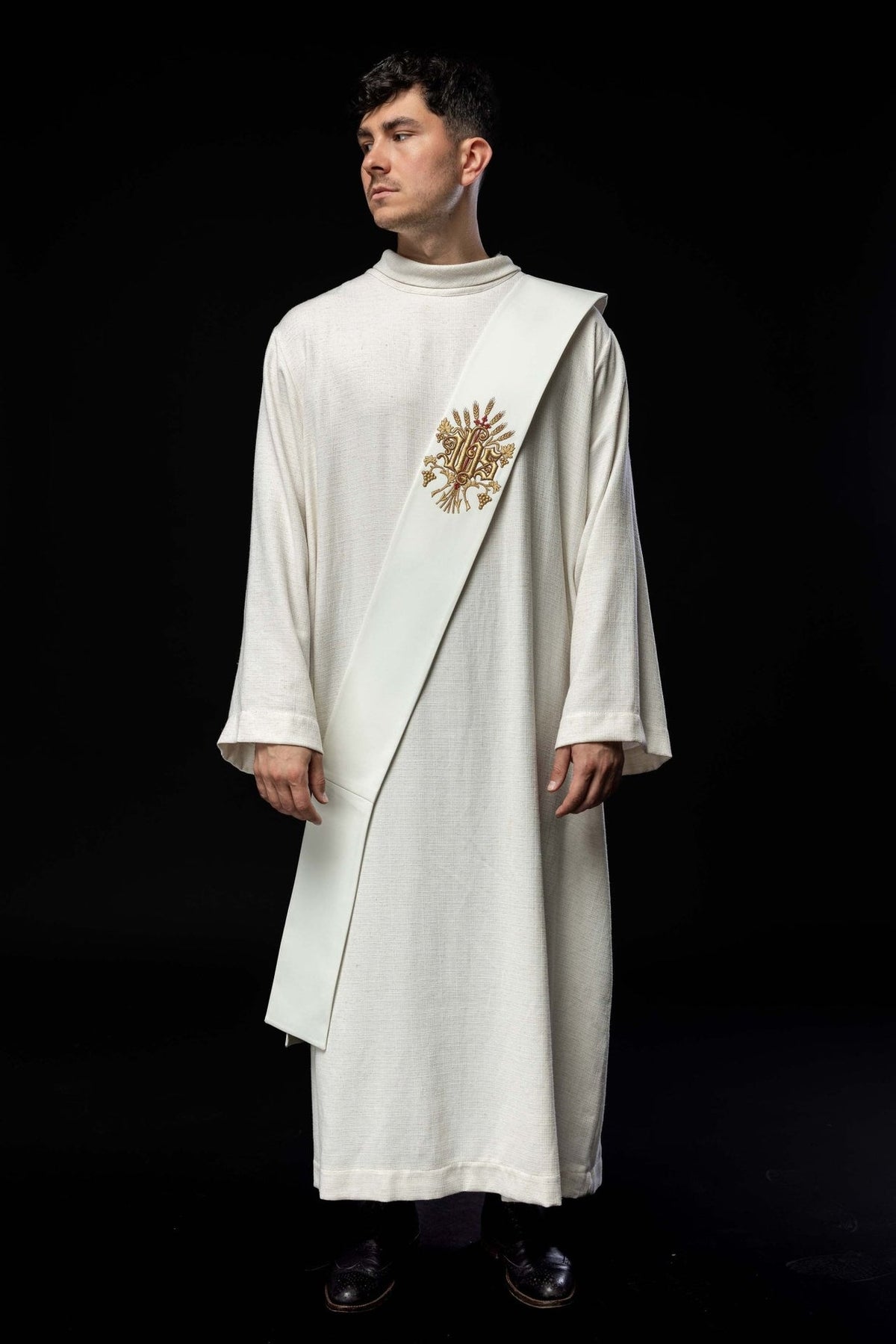 White deacon stole worn from the front, showing its full length and embroidered grapes, wheat and cross