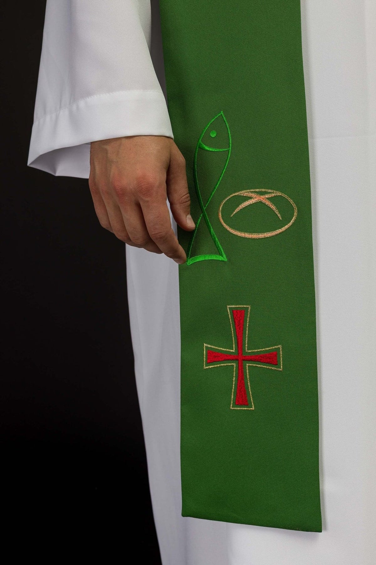 Green priest stole close-up with embroidered fish, bread and red cross motifs