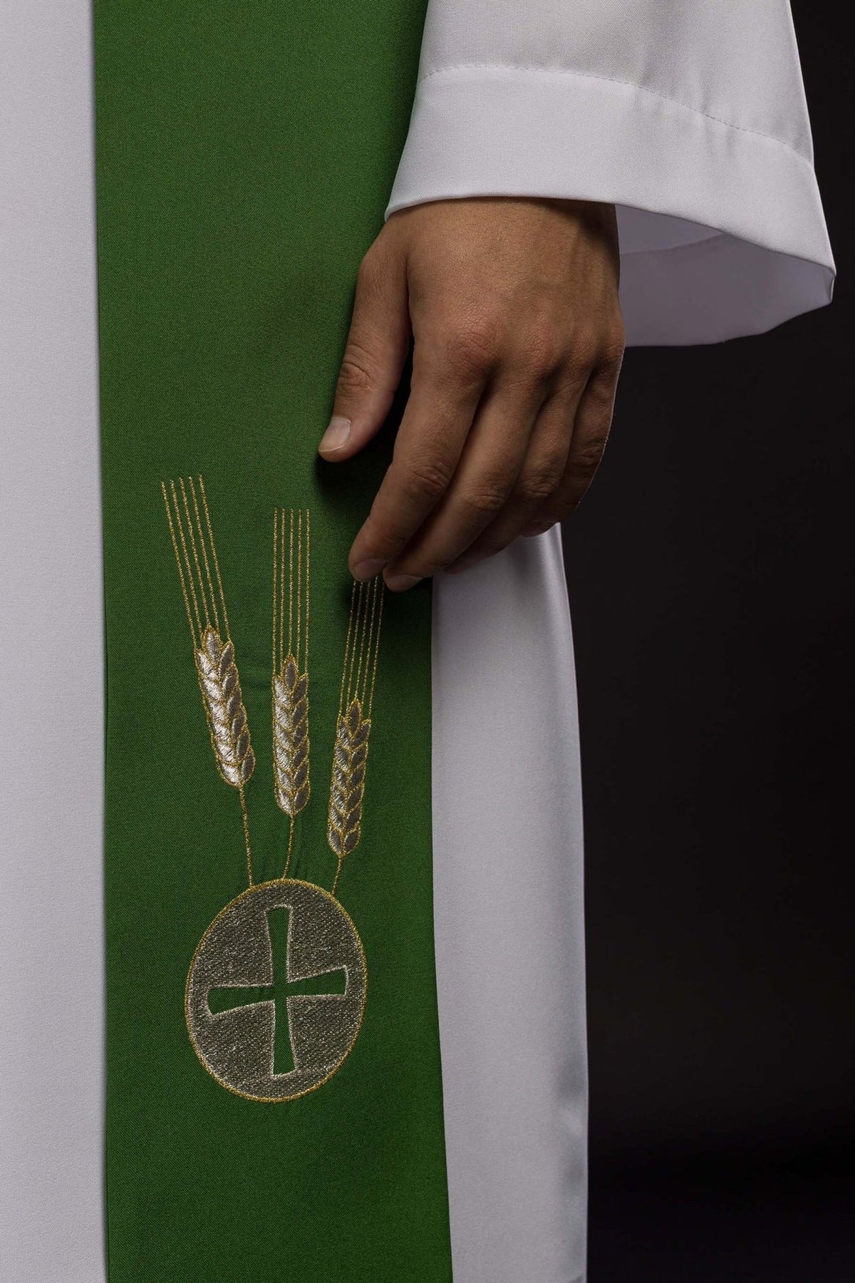 Green stole close-up showing embroidered wheat and cross