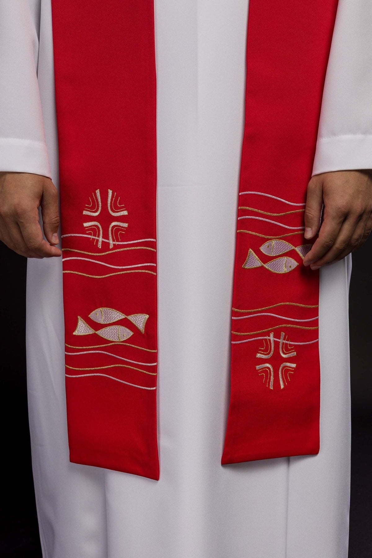 Red priest stole close-up showing fish, cross motifs and wavy embroidery