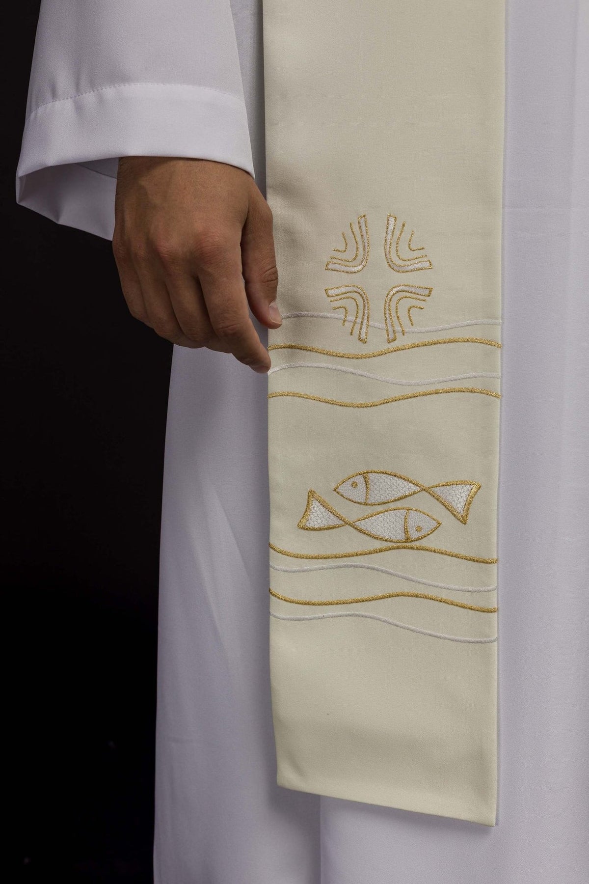 Ecru priest stole close-up with gold embroidery, fish and wavy line motifs