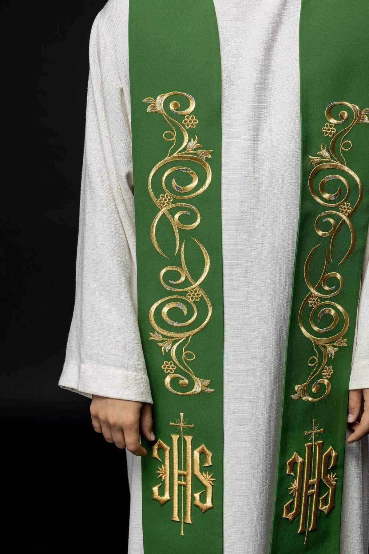 Green stole worn from the front, showing symmetrical gold scrollwork and IHS embroidery