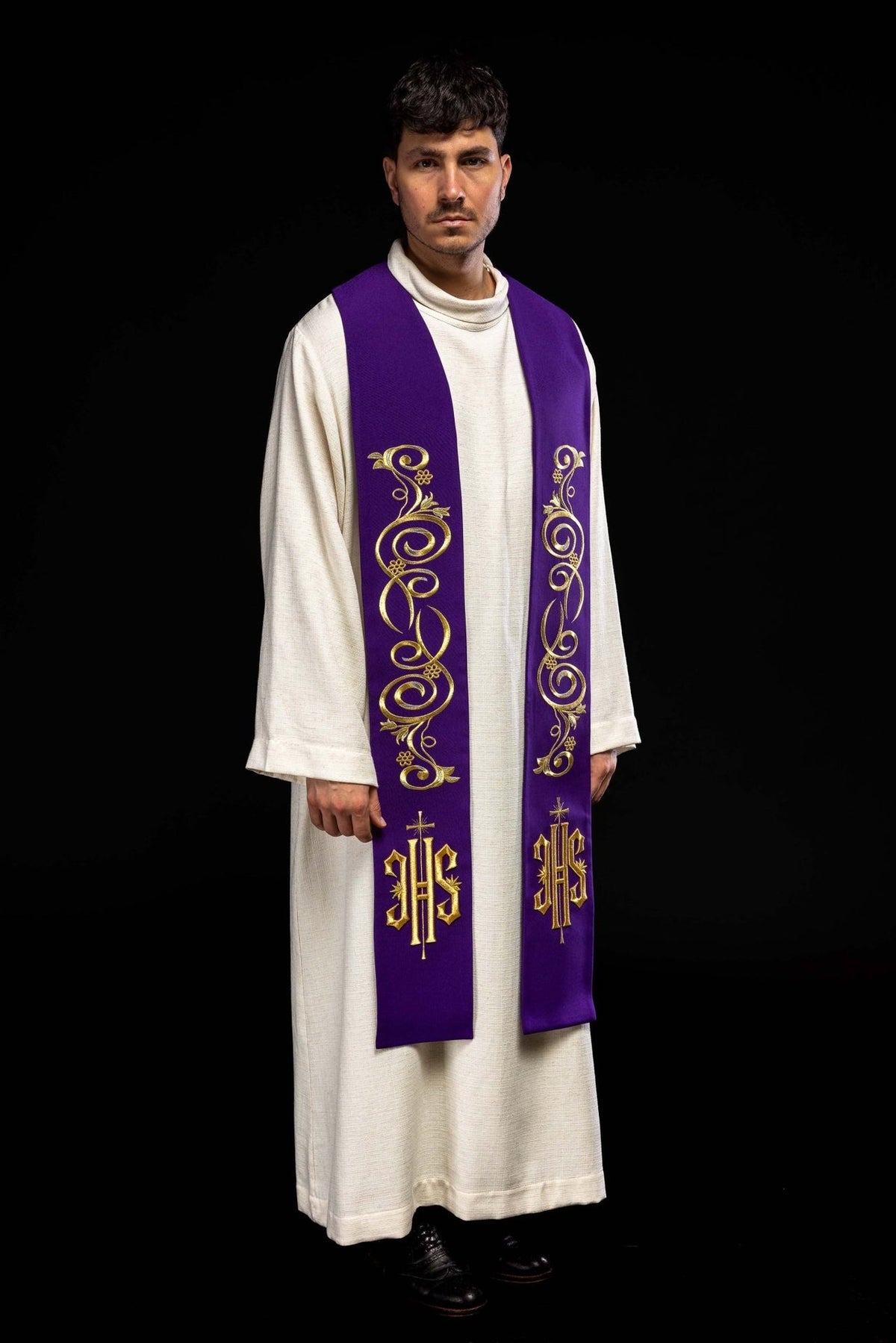 Embroidered purple stole worn front view with gold scroll embroidery and IHS symbols