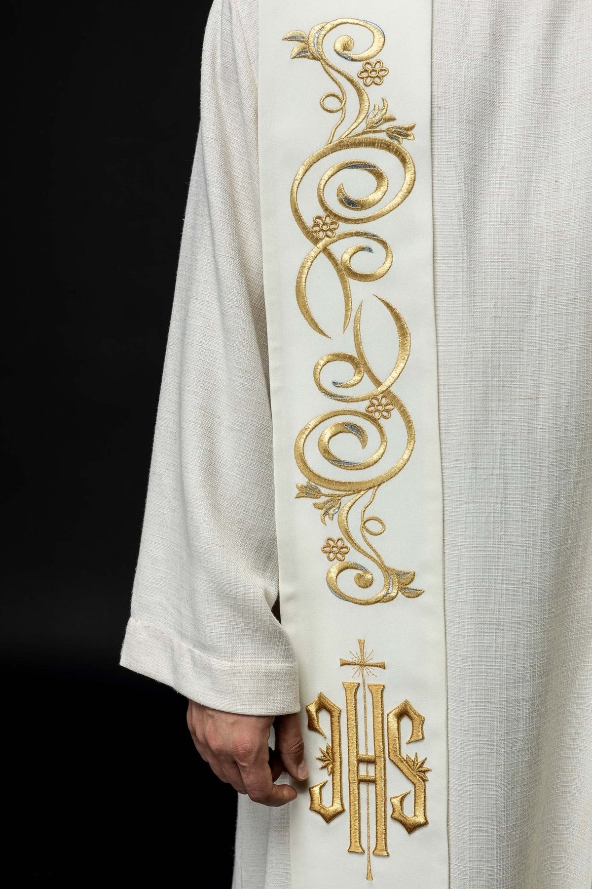 Ecru stole close-up showing ornate gold embroidery and IHS motif