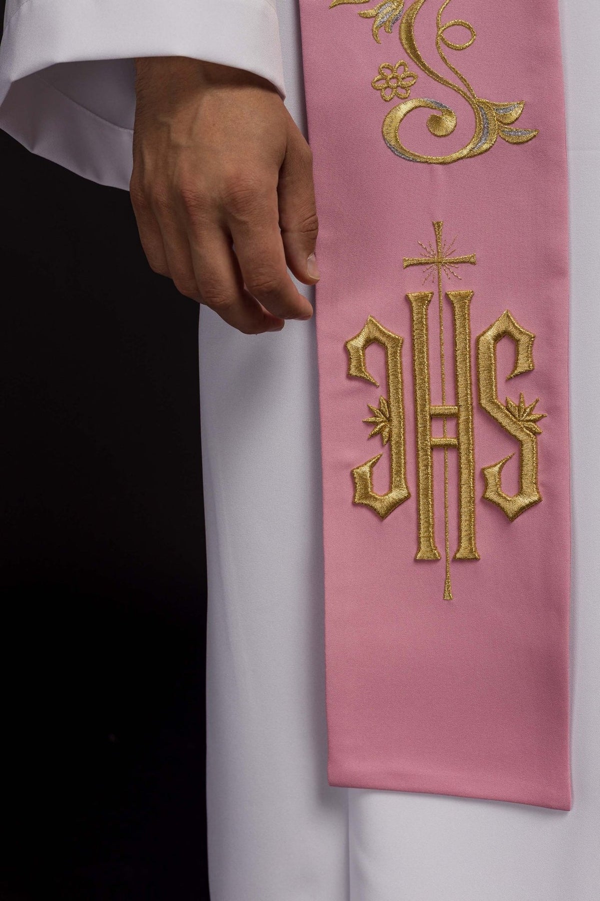Pink priest stole close-up showing gold embroidered IHS and floral scrollwork