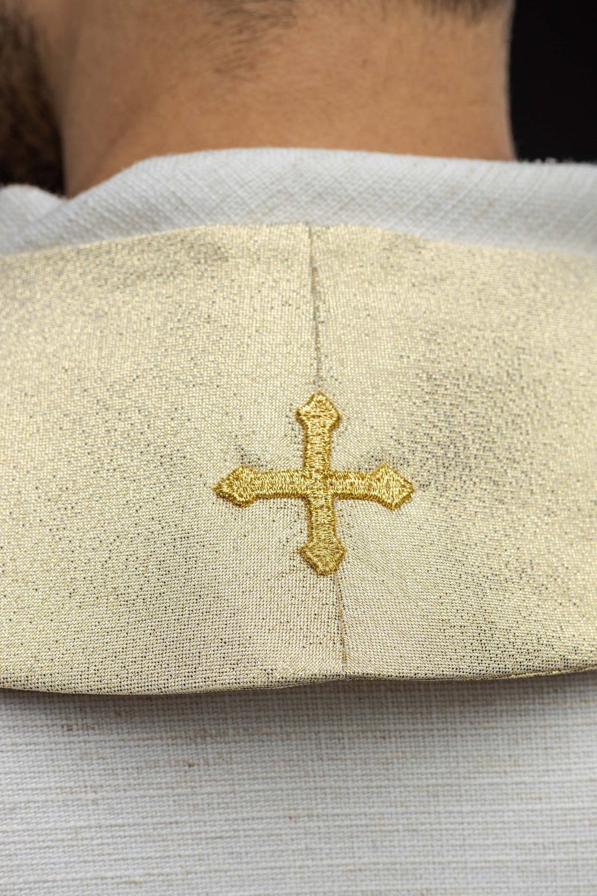 Gold Catholic stole close-up showing center seam and embroidered cross