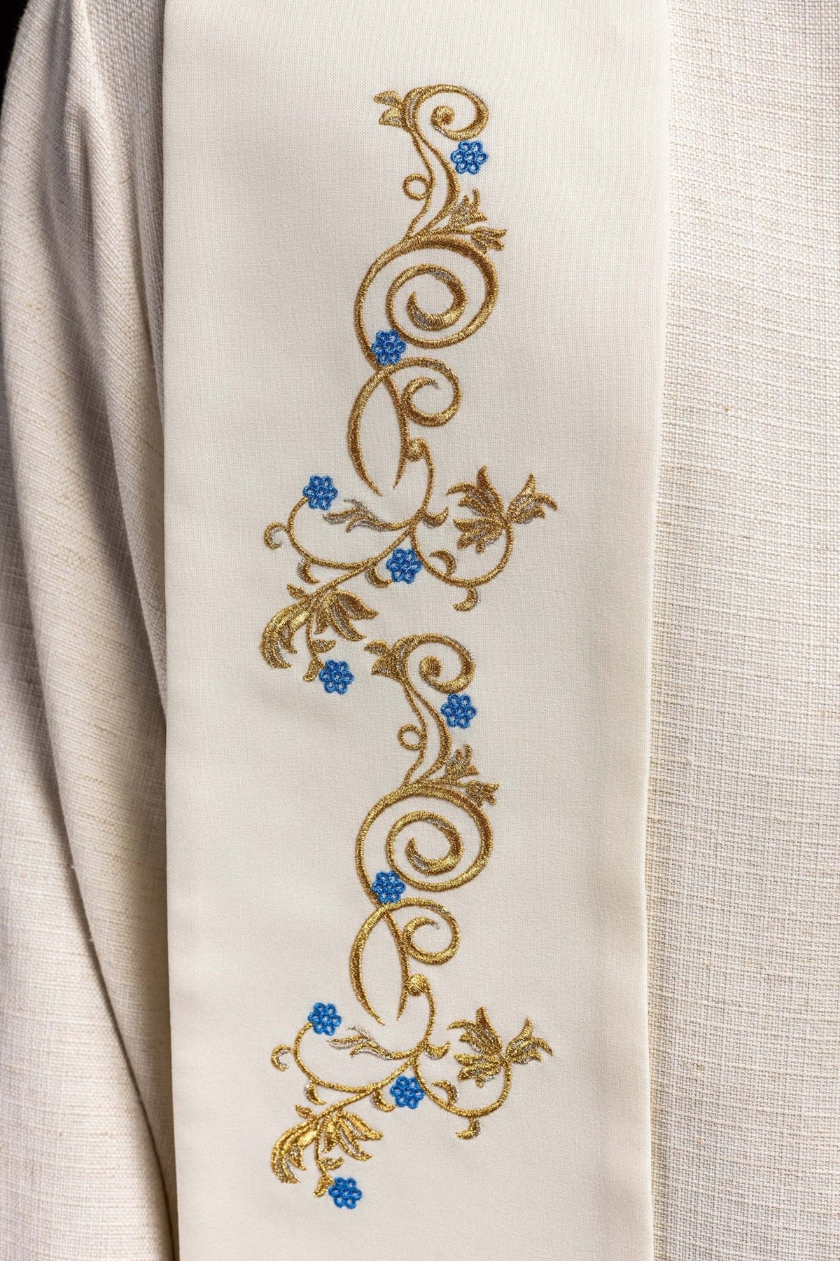 Embroidered Marian stole detail with gold scrollwork and blue flowers