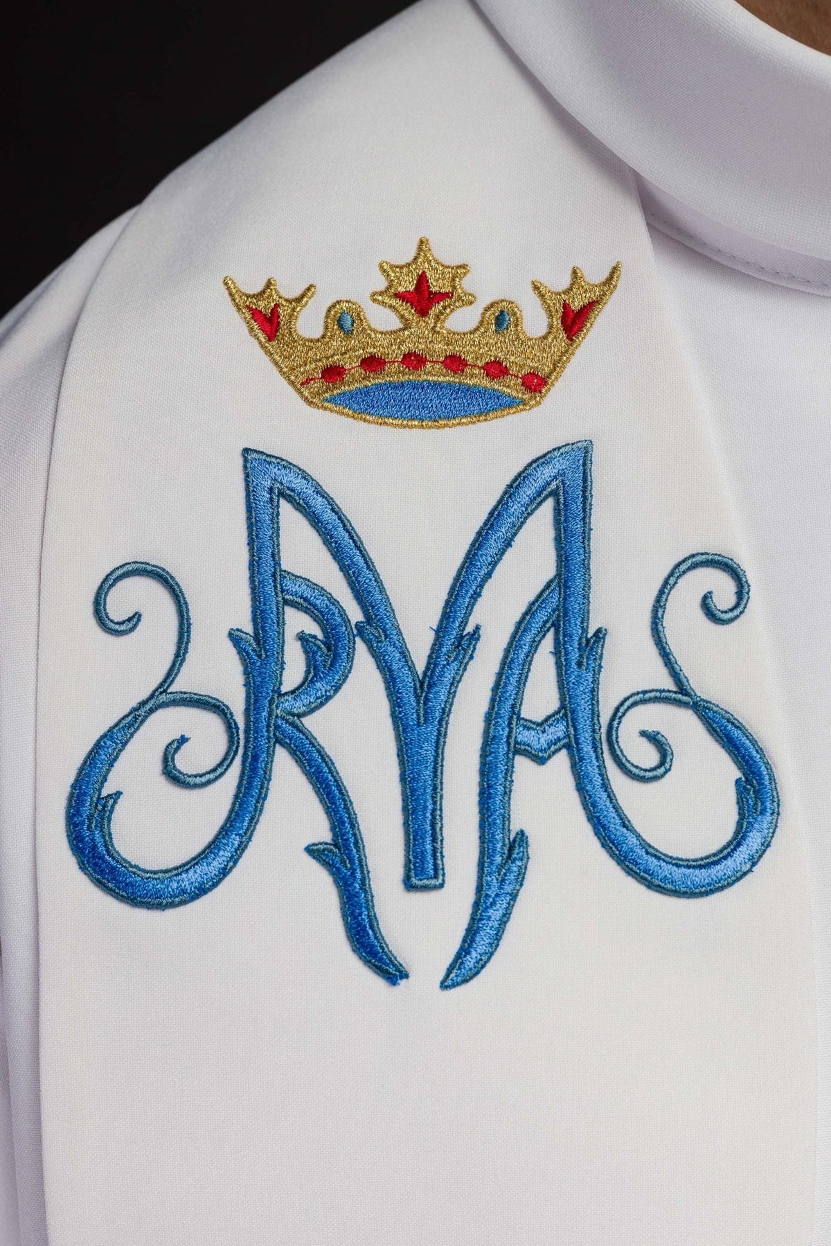 Priest stole close-up with blue Marian symbol and embroidered crown