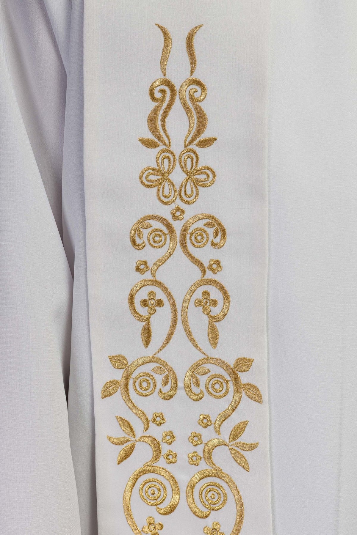 White stole close-up showing gold embroidered scrollwork and floral motifs