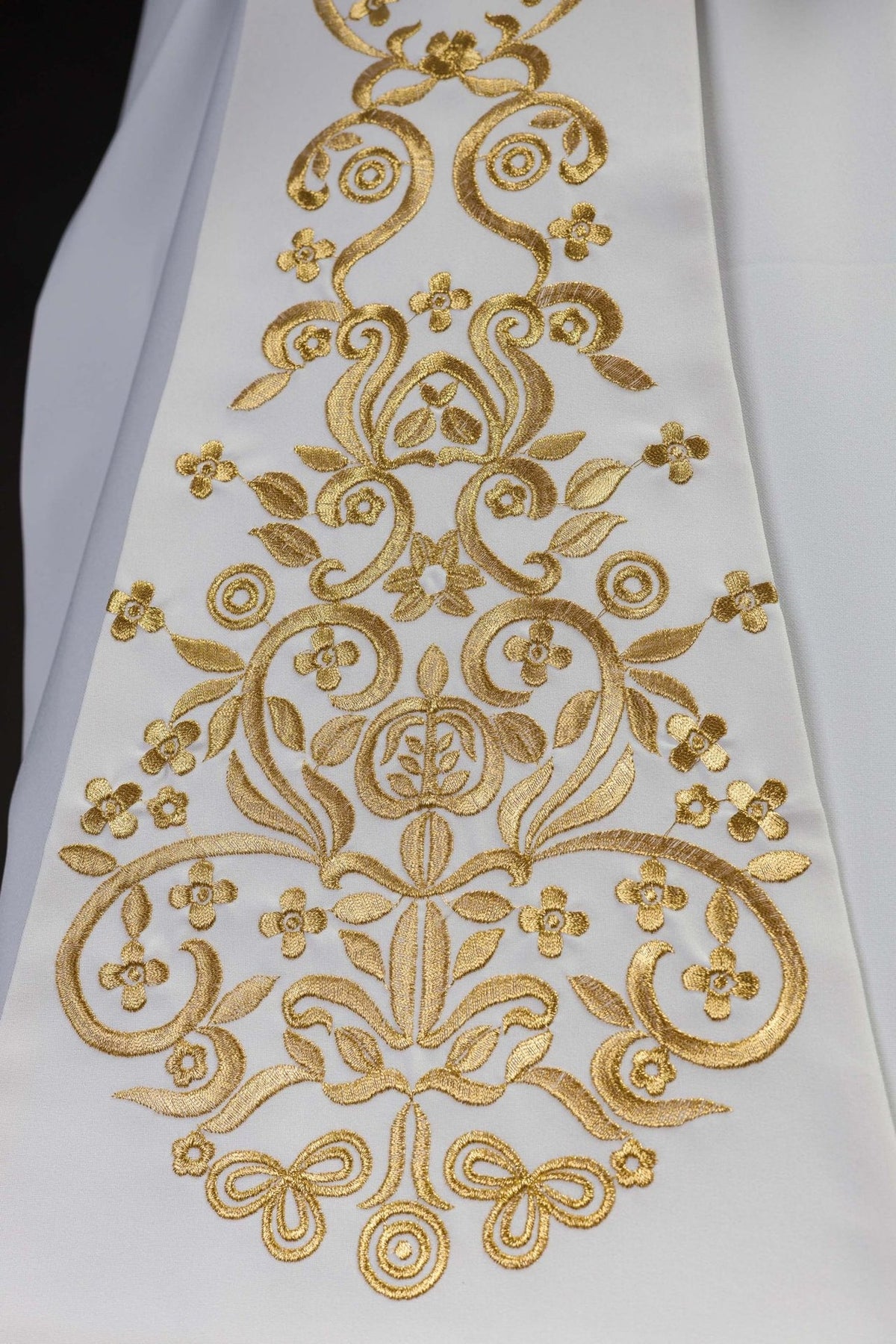Priest stole detail showing dense gold embroidery with floral and scrollwork motifs