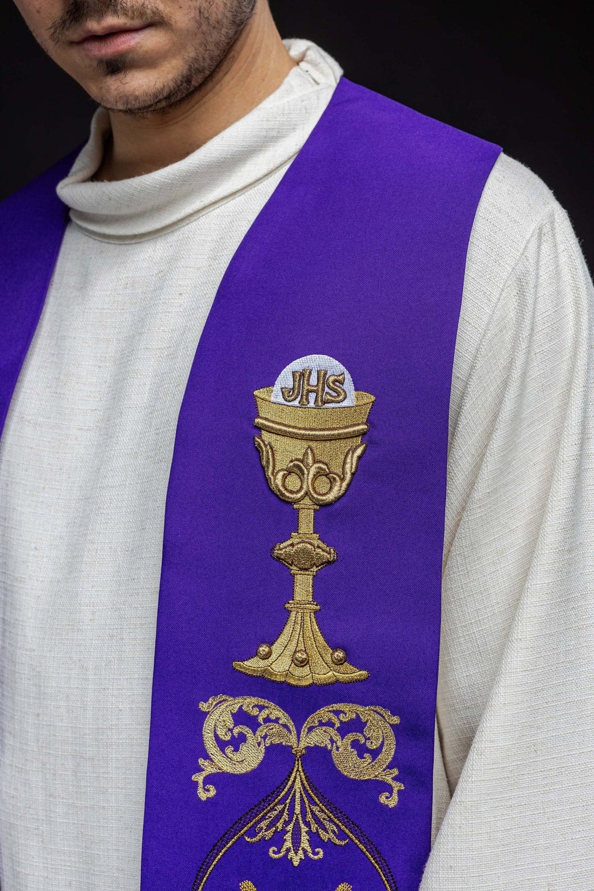 Purple priest stole close-up with gold chalice and IHS embroidery
