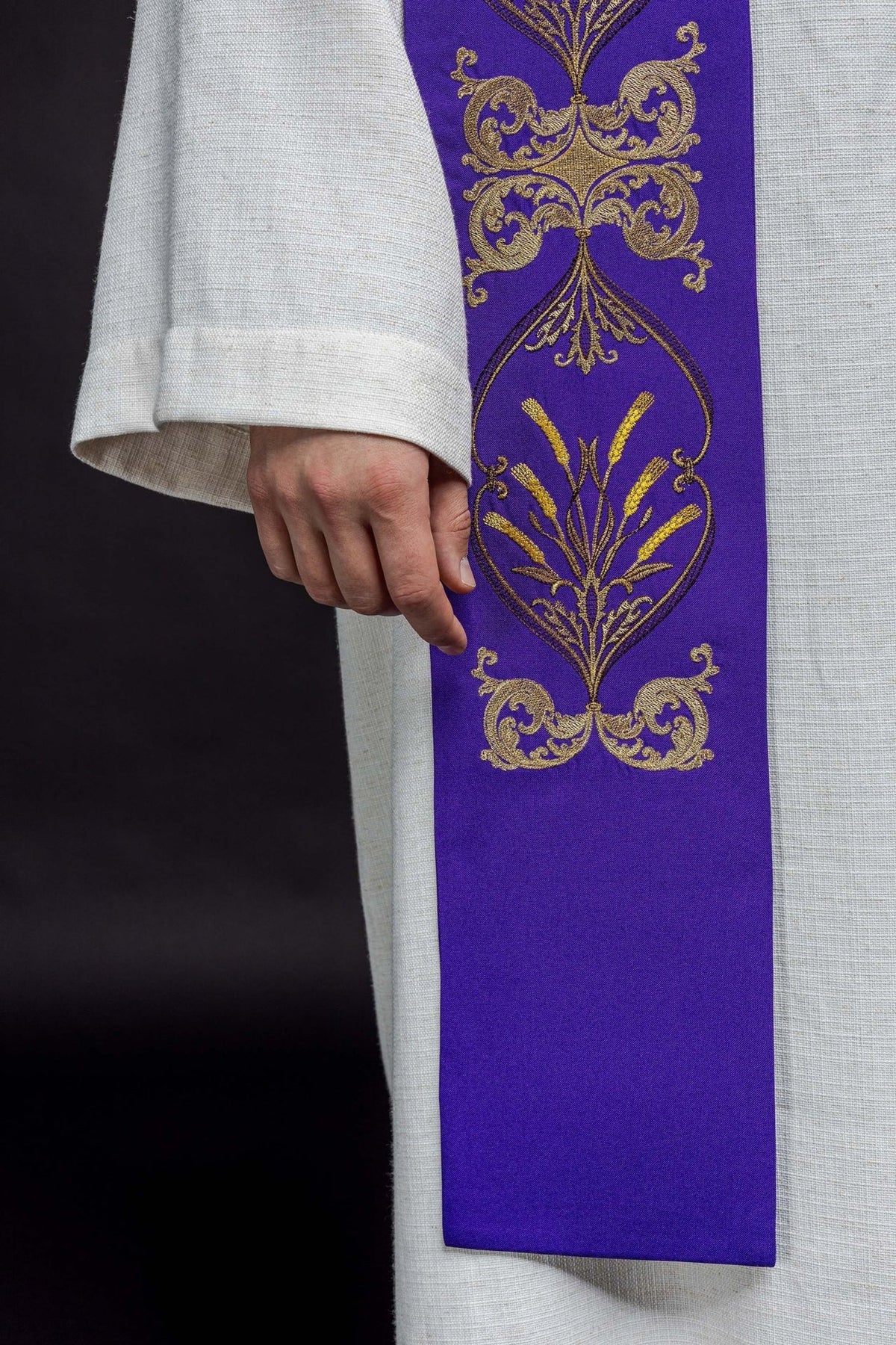 Purple stole detail with gold floral embroidery and purple fabric