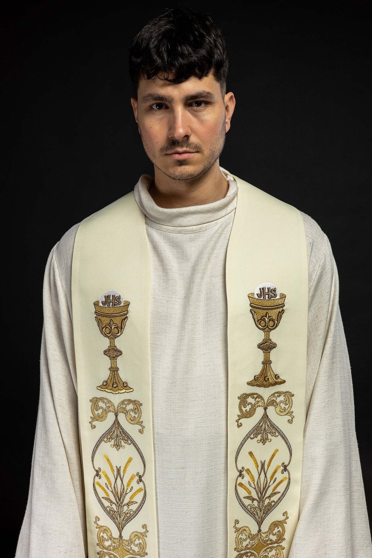 Ecru priest stole close-up showing gold chalice and IHS embroidery