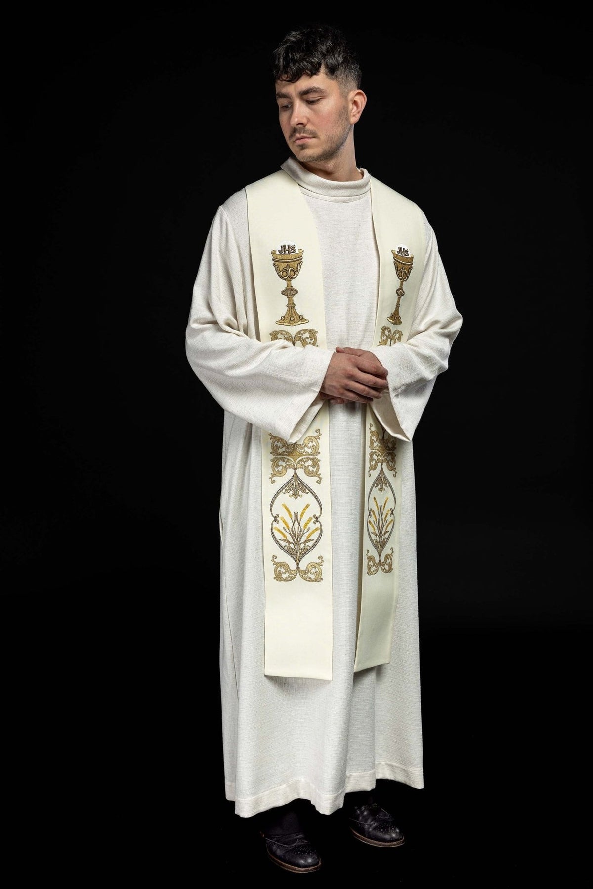 Ecru priest stole worn in a three-quarter front view with gold embroidery