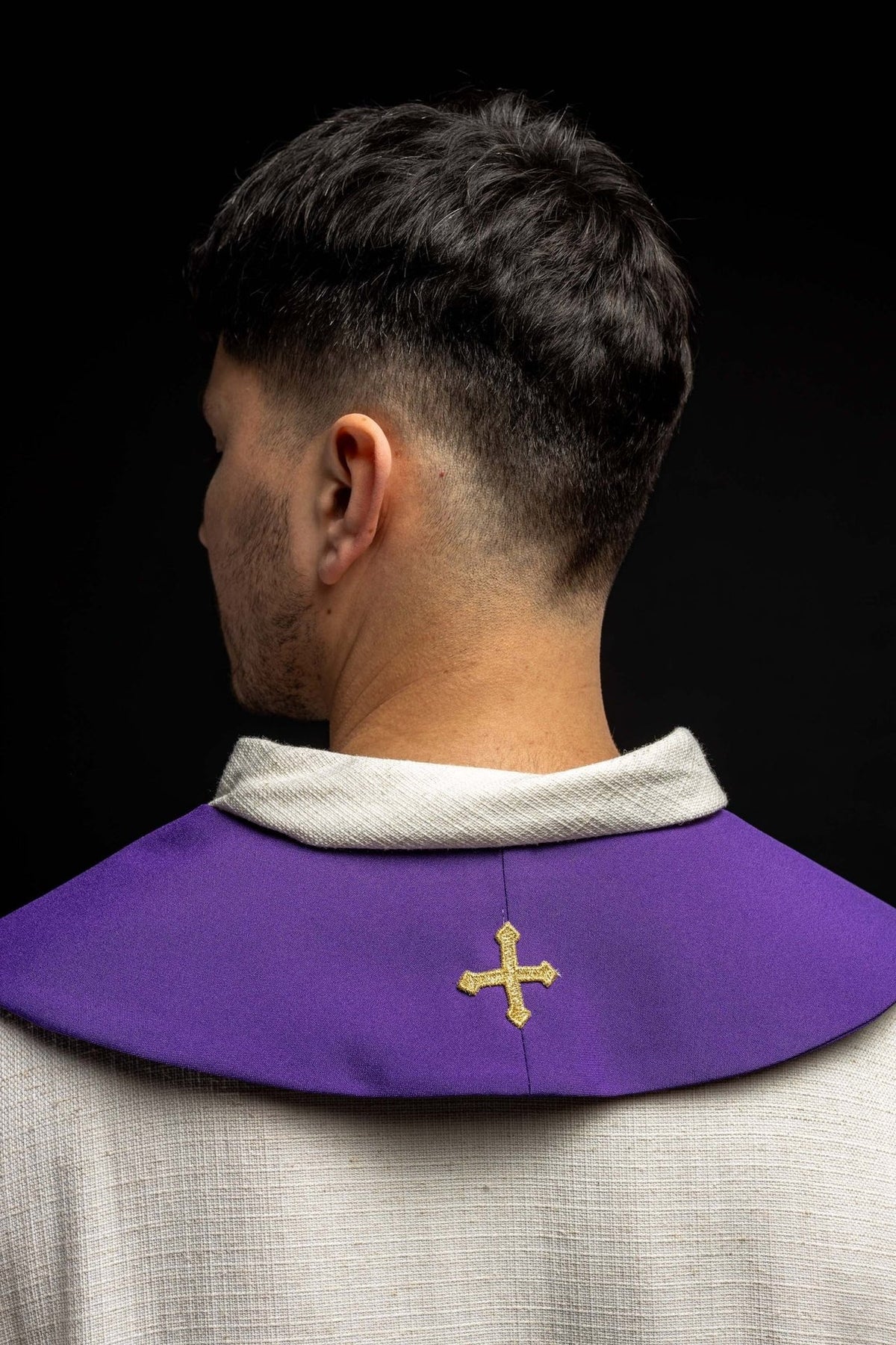 Purple stole back view with gold embroidered cross and white edging