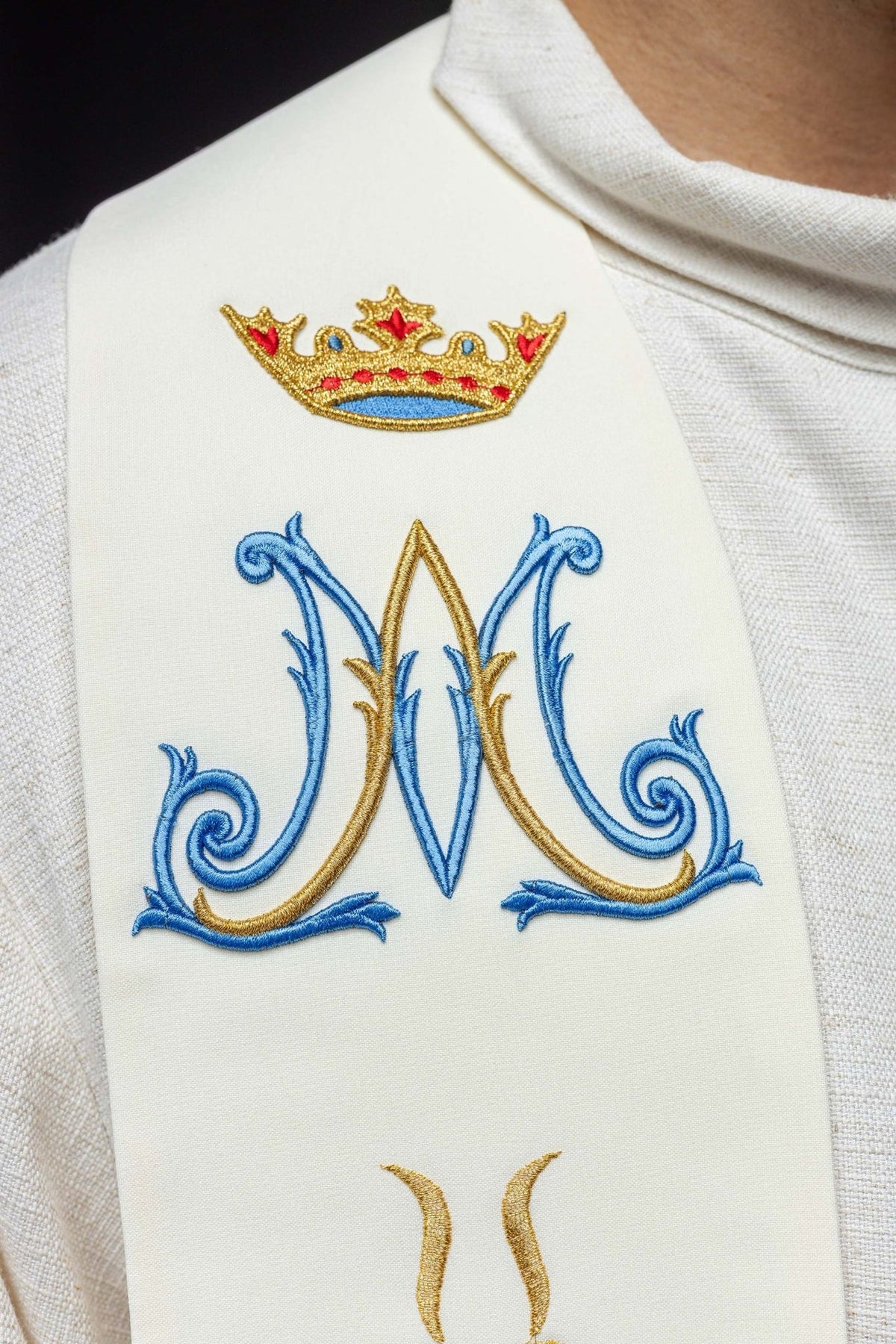 Marian ecru stole detail with embroidered crown and blue Marian symbol