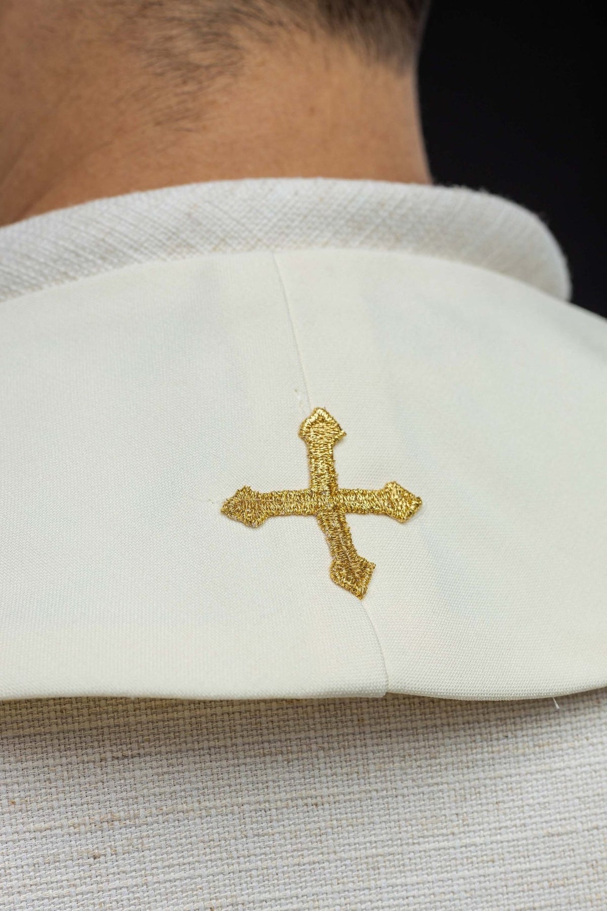 Marian ecru stole close-up showing a small gold embroidered cross at the neck