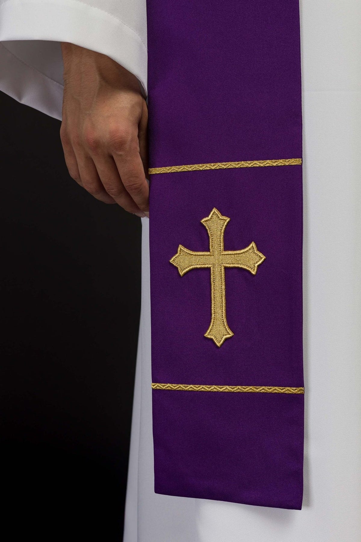 Purple priest stole close-up with gold embroidered cross and trim