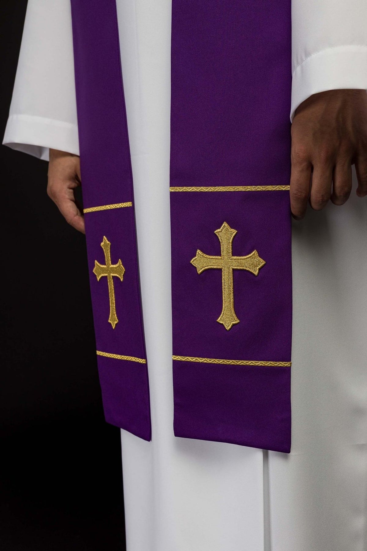Purple stole front detail showing embroidered gold crosses and trim