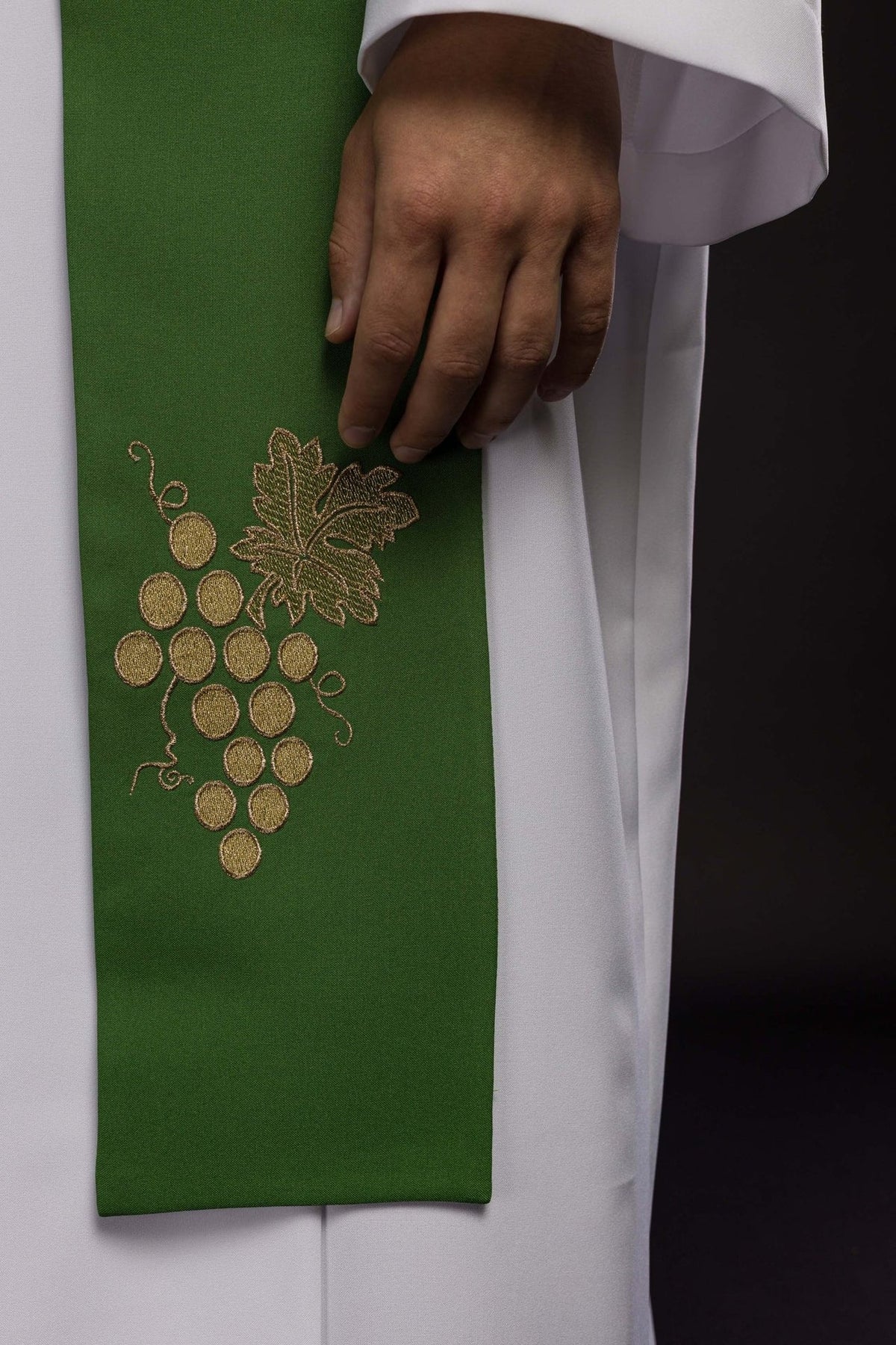 Green stole close-up with embroidered grapes and leaf motif