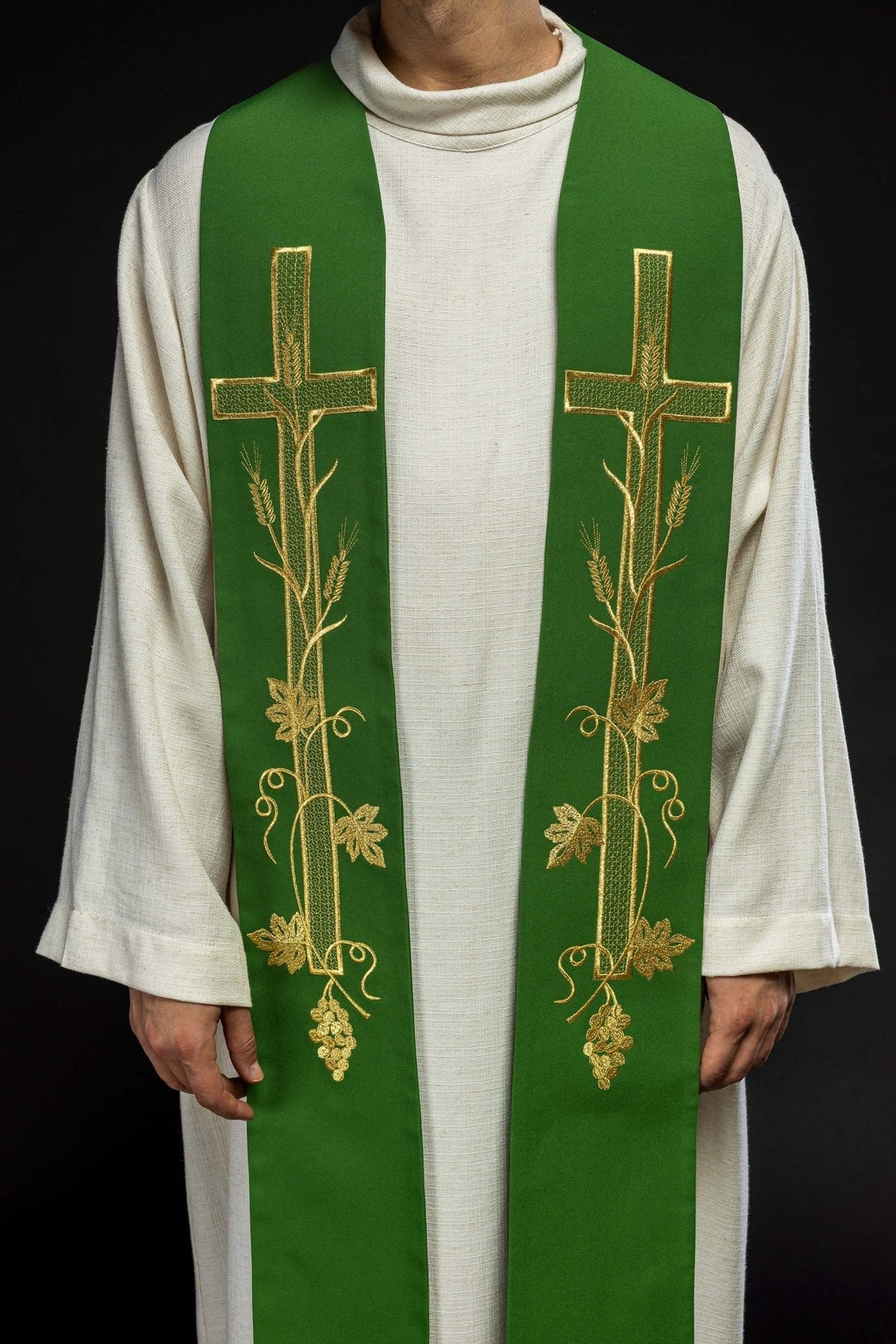 Green priest stole close-up showing gold cross, vine, wheat and grape embroidery