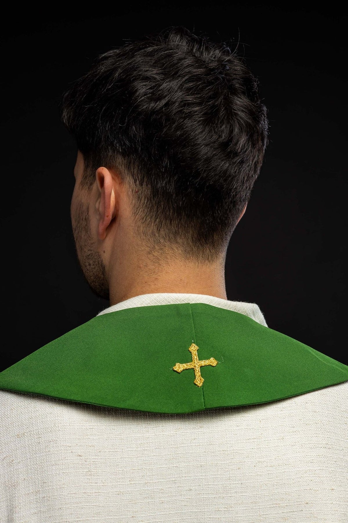Green stole back view showing a small gold cross at the neck