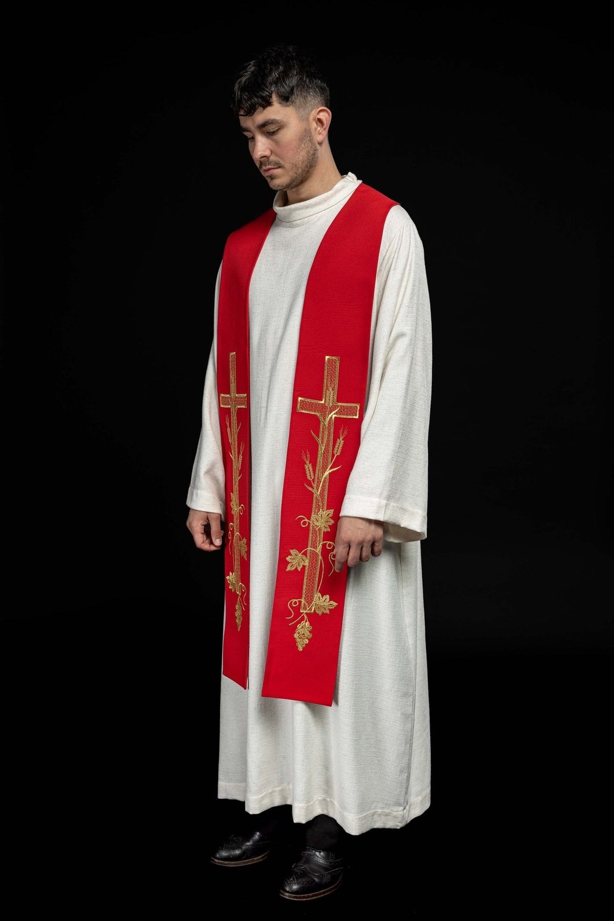 Red embroidered priest stole worn in a three-quarter front view